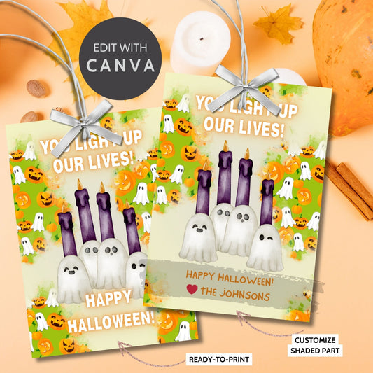 Halloween-themed printable gift tags with the message "You Light Up Our Lives!" designed for candle gifts, featuring cute ghost characters and glowing candles on a festive background. Tags are 2.5 x 3.5 inches, laid out 8 per sheet on a standard 8.5 x 11-inch page. Includes a printable PDF and a PDF with a link to an editable Canva template.