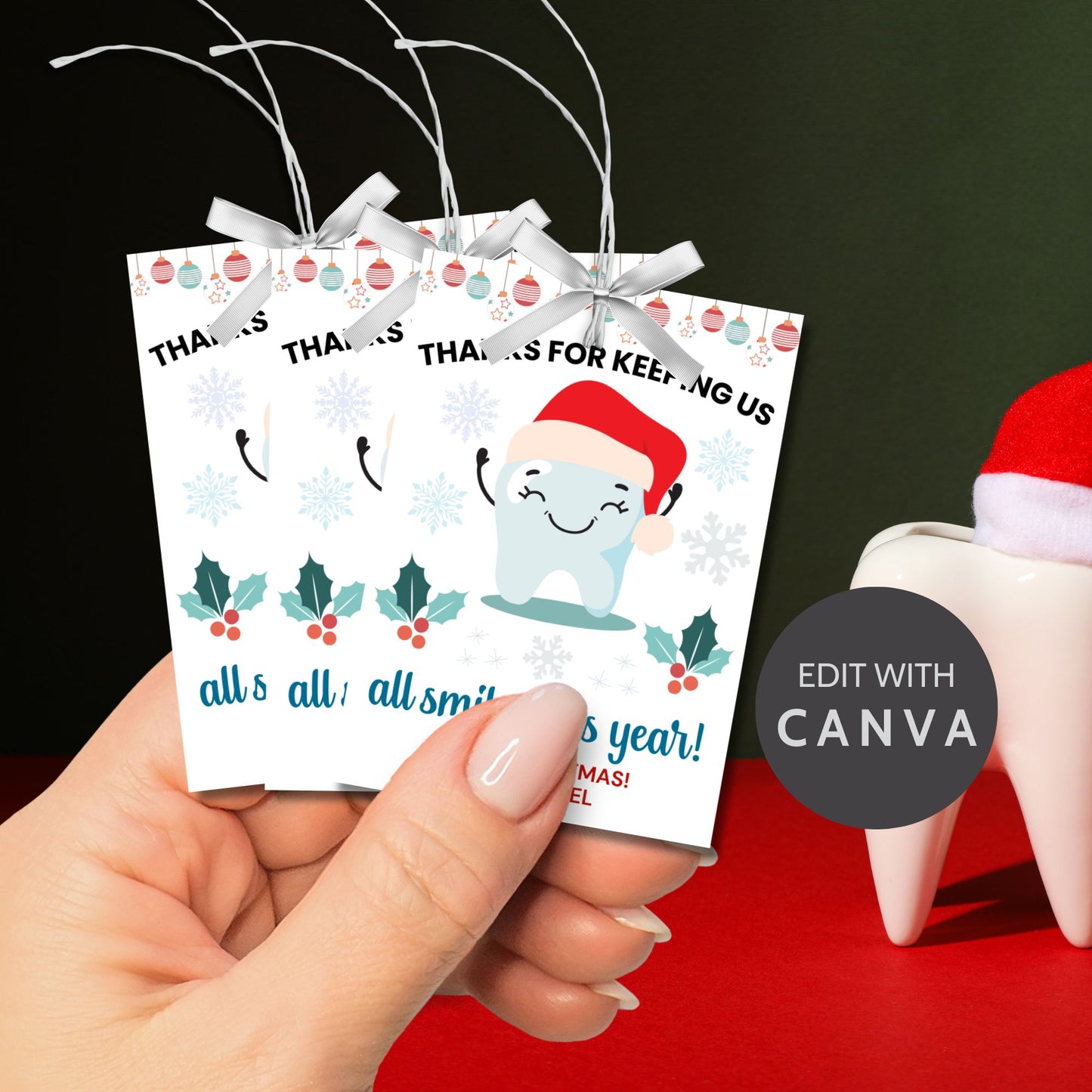 A festive set of 8 editable holiday gift tags with the message 'Thanks for Keeping Us All Smiles This Year!' featuring a smiling tooth in a Santa hat, holly, snowflakes, and hanging baubles. Perfect for dentists and dental offices to use for holiday gifts or client appreciation.
