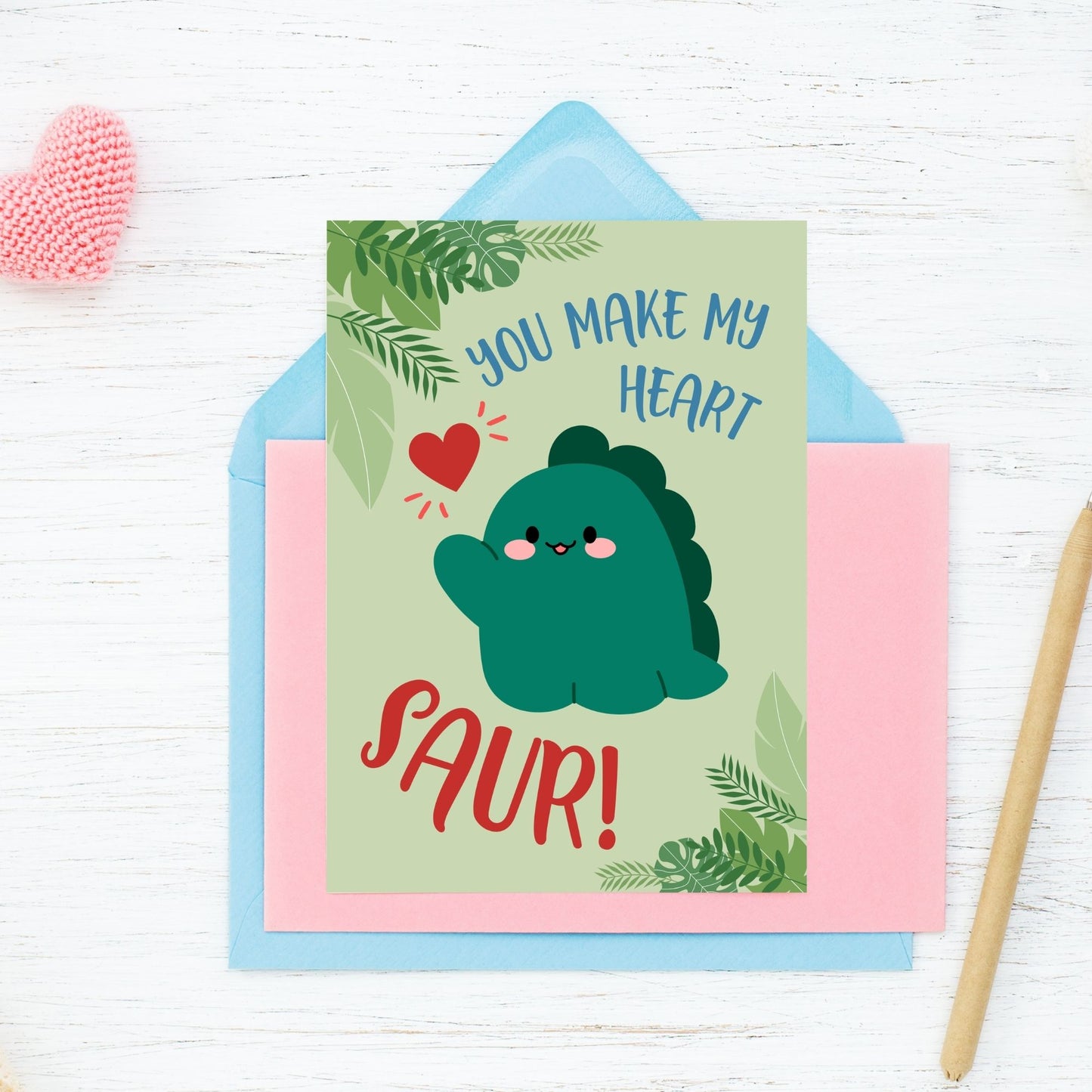 Printable Valentineās Day Greeting Card featuring the pun āYou Make My Heart Saur.ā Designed as a 5x7 PDF on an 8.5 x 11 sheet with two cards per page. A fun and adorable Valentineās card for dinosaur lovers!