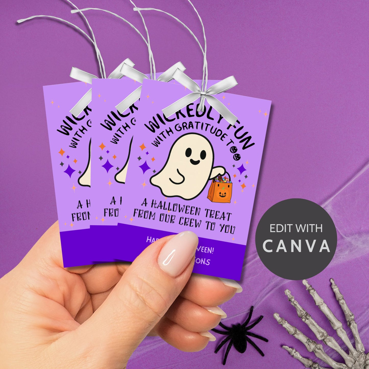 Halloween-themed gift tags with a ghost illustration on a purple background, held by a hand.