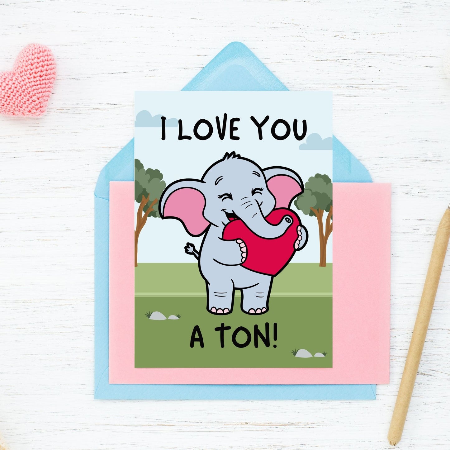 Printable Valentineās Day Greeting Card featuring the phrase āI Love You a Tonā with an elephant theme. Designed as a 5x7 PDF on an 8.5 x 11 sheet with two cards per page. A cute and heartfelt Valentineās card for loved ones.