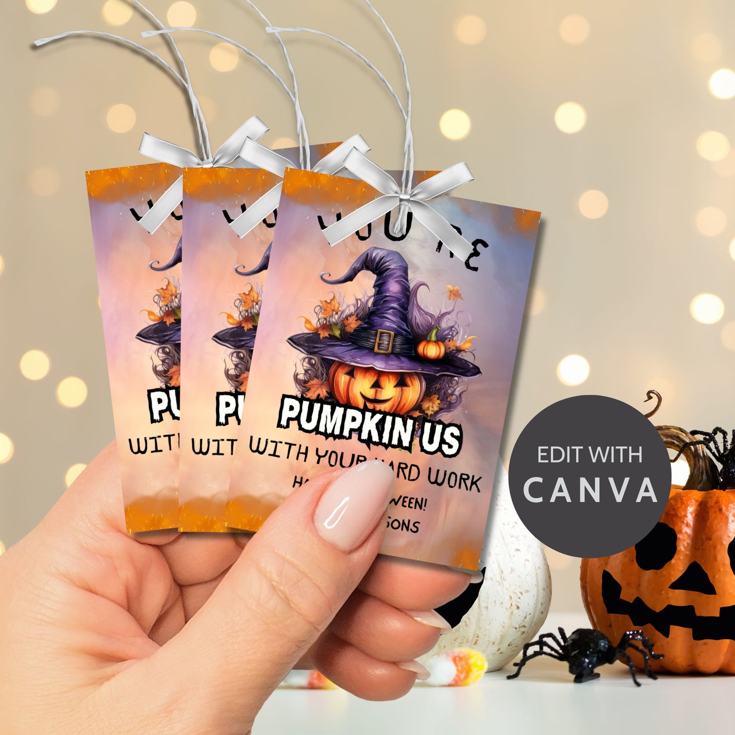Halloween-themed printable gift tags with the message "You're Pumpkin Us With Your Hard Work" featuring a festive pumpkin in a witch's hat on a Halloween background. Tags are 2.5 x 3.5 inches, laid out 8 per sheet on a standard 8.5 x 11-inch page. Includes a printable PDF and a PDF with a link to an editable Canva template.