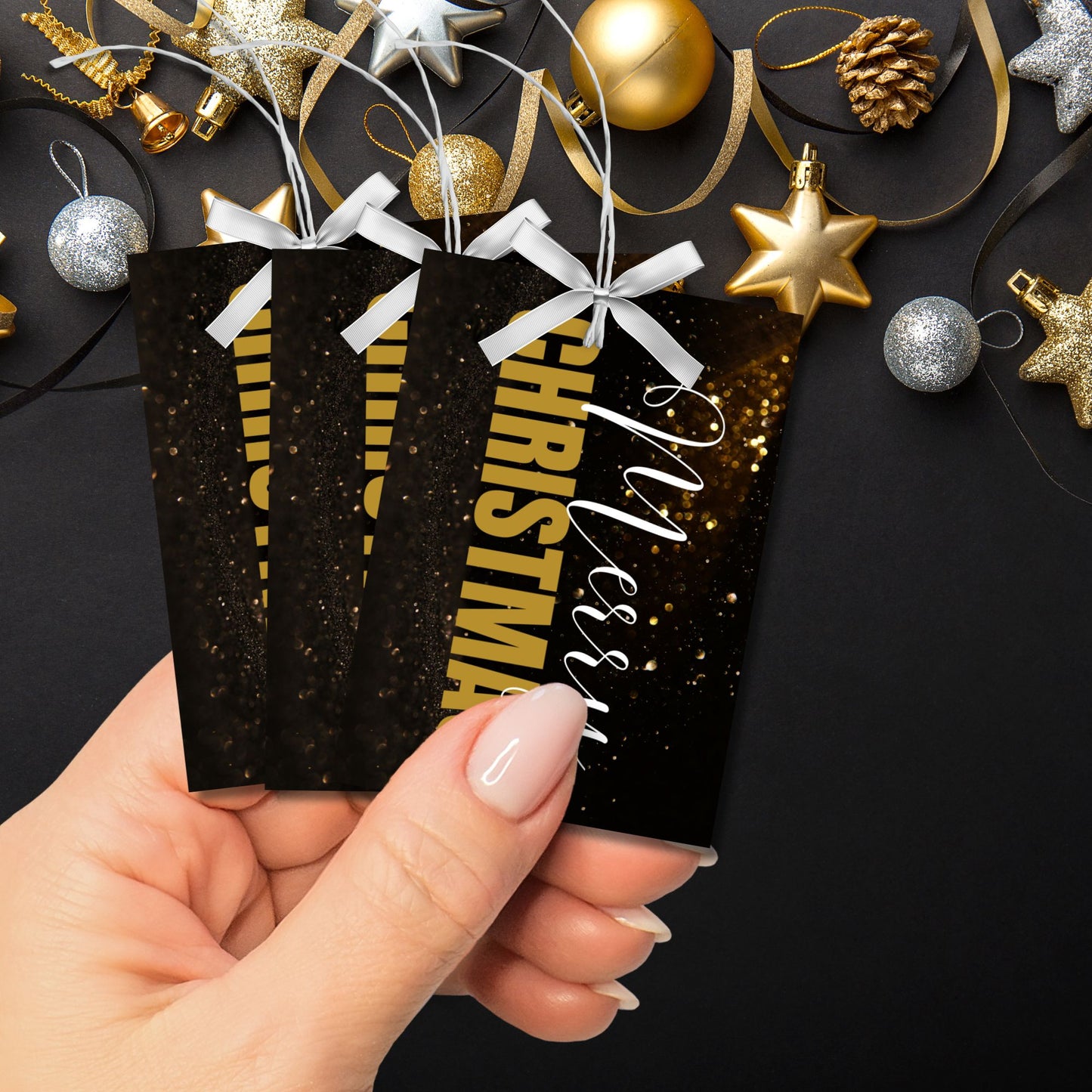 A set of ready-to-print Christmas gift tags with elegant gold and white text on a black background. The "Merry Christmas" message is paired with a sparkling gold design, adding a touch of glamour to holiday gifting. Tags are 2.5 x 3.5 inches in size, perfect for chic and classy gift wrapping.