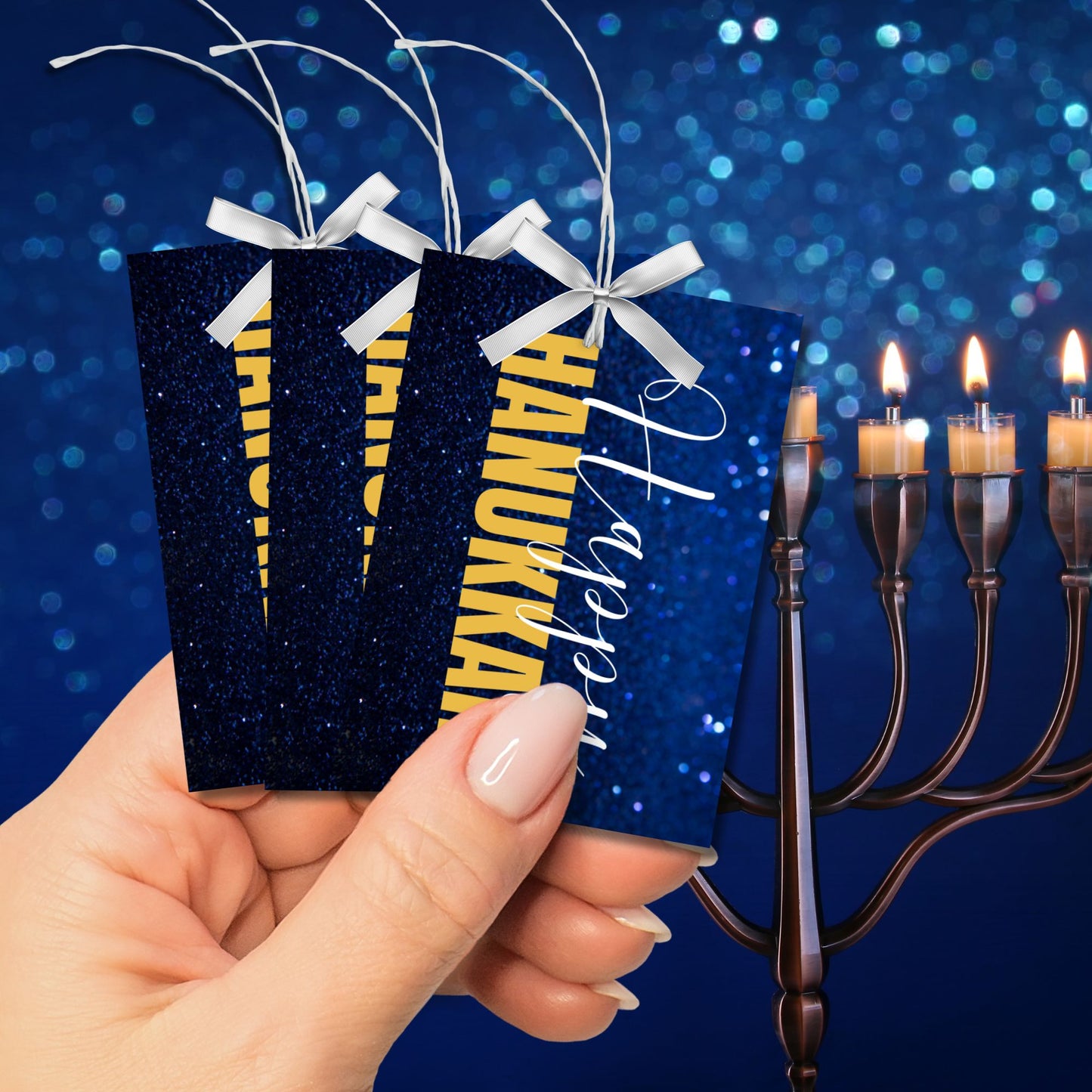 A set of Happy Hanukkah gift tags featuring "Happy Hanukkah" in white and gold text on a glittering blue background. Perfect for festive gift wrapping during the Festival of Lights.