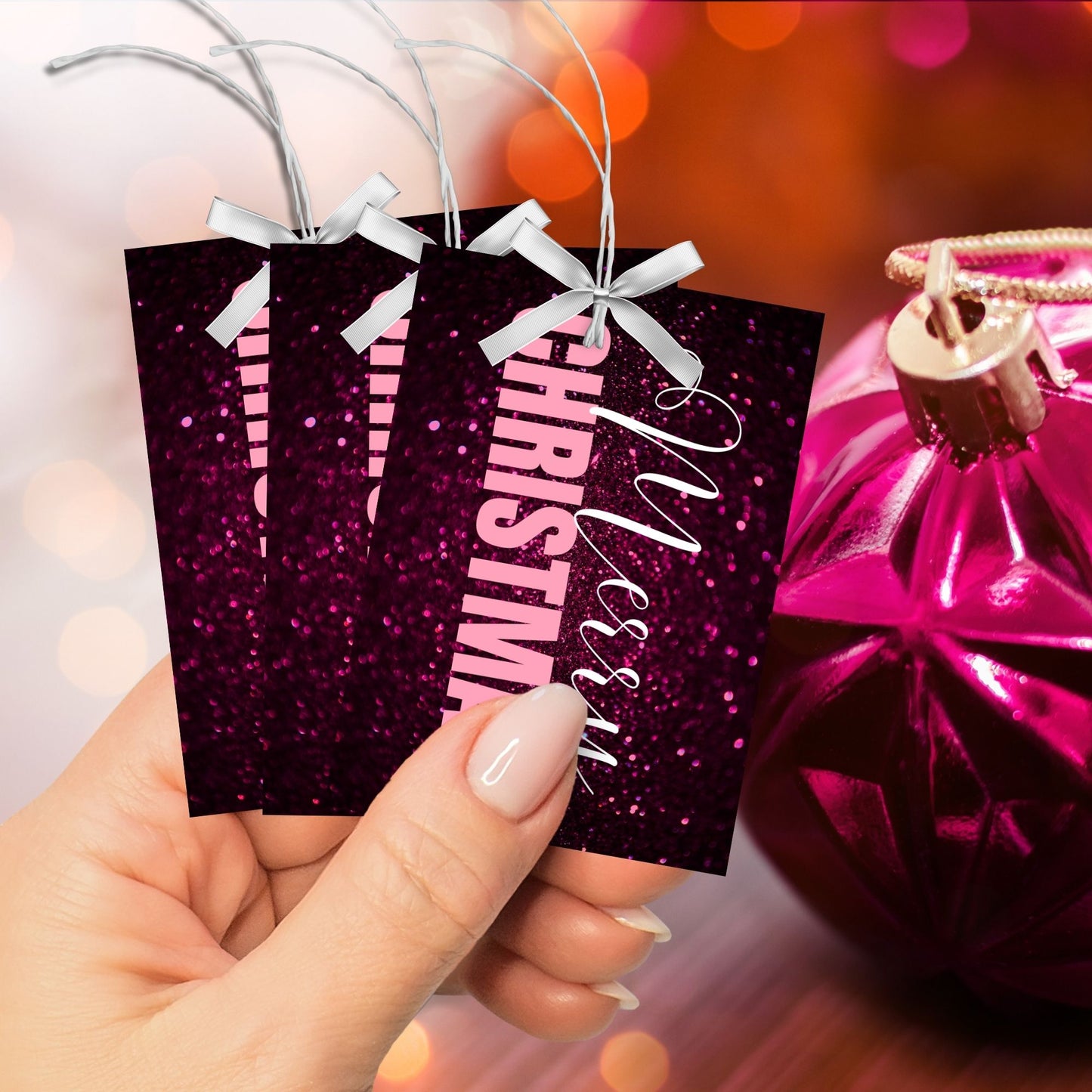 Printable pink and magenta Christmas gift tags featuring a glittery magenta background with light pink "Merry Christmas" text, sized 2.5 x 3.5 inches, 8 tags per sheet.