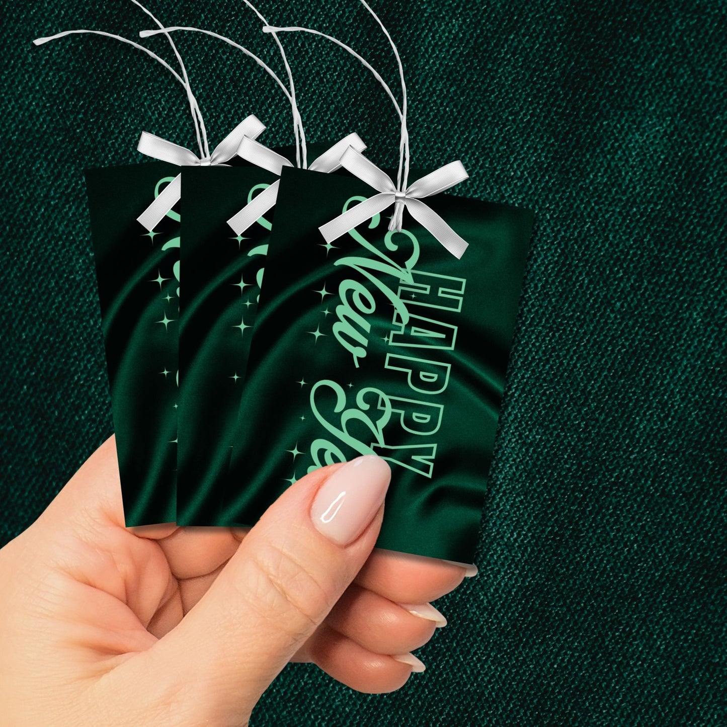 Elegant emerald green Happy New Year printable gift tags with a satin-inspired background and shimmering accents, ideal for luxury gifting and party favors.