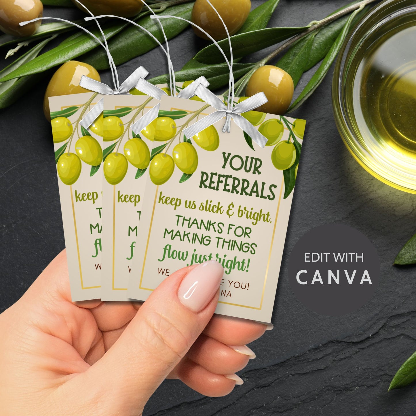 A printable PDF of olive oil-themed referral gift tags titled "Your Referrals Keep Us Slick and Bright," customizable in Canva.