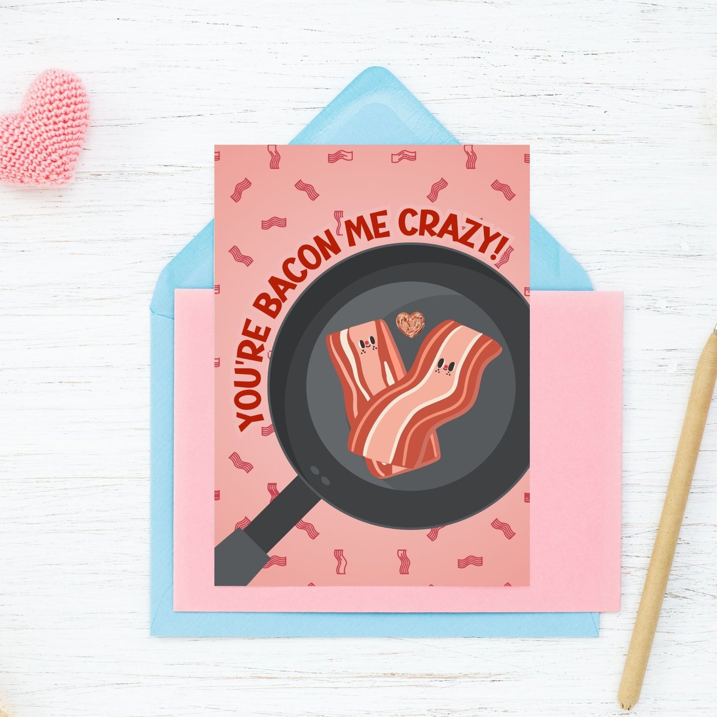 Printable Valentine’s Day Greeting Card featuring the phrase “You’re Bacon Me Crazy” with a bacon theme. Designed as a 5x7 PDF on an 8.5 x 11 sheet with two cards per page. A fun and punny Valentine’s card for bacon lovers and friends.