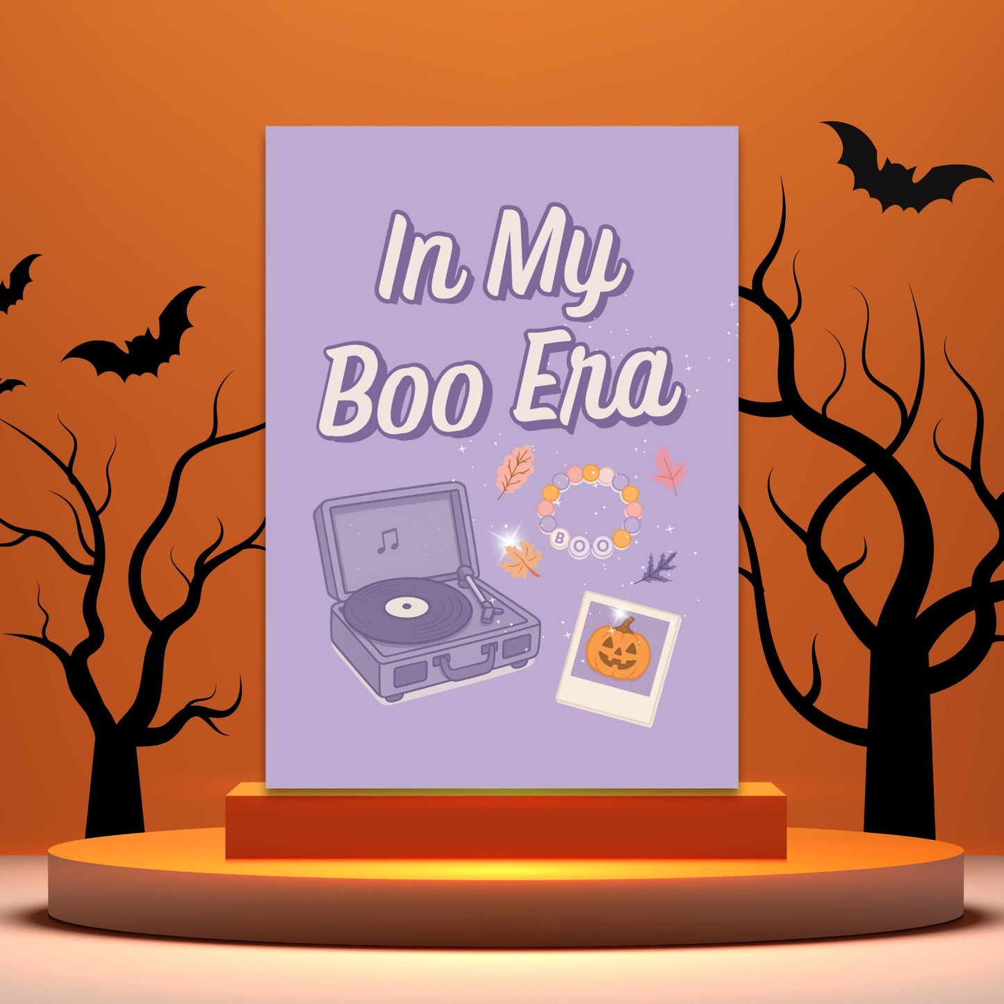 Halloween-themed card with 'In My Boo Era' text, record player, and pumpkins on a purple background.