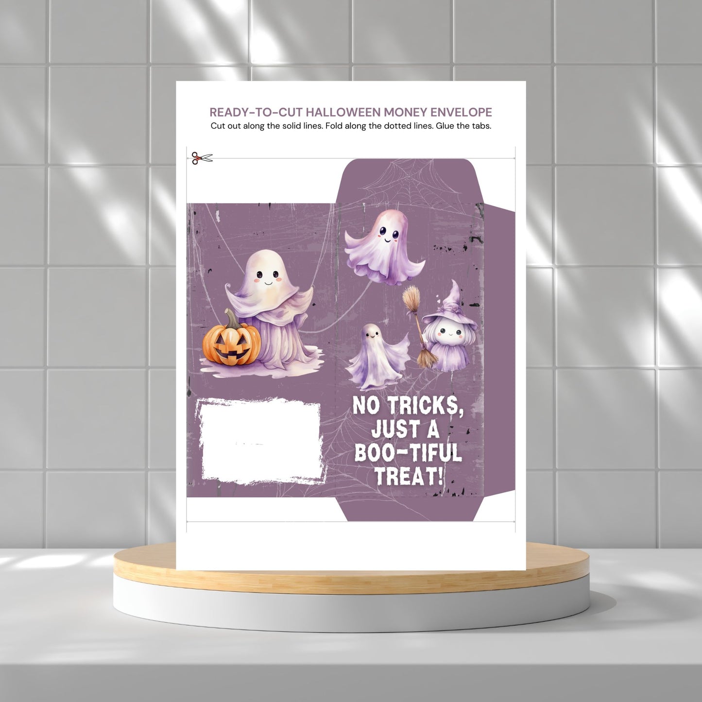 Halloween money envelope with ghost illustrations on a gray tiled background