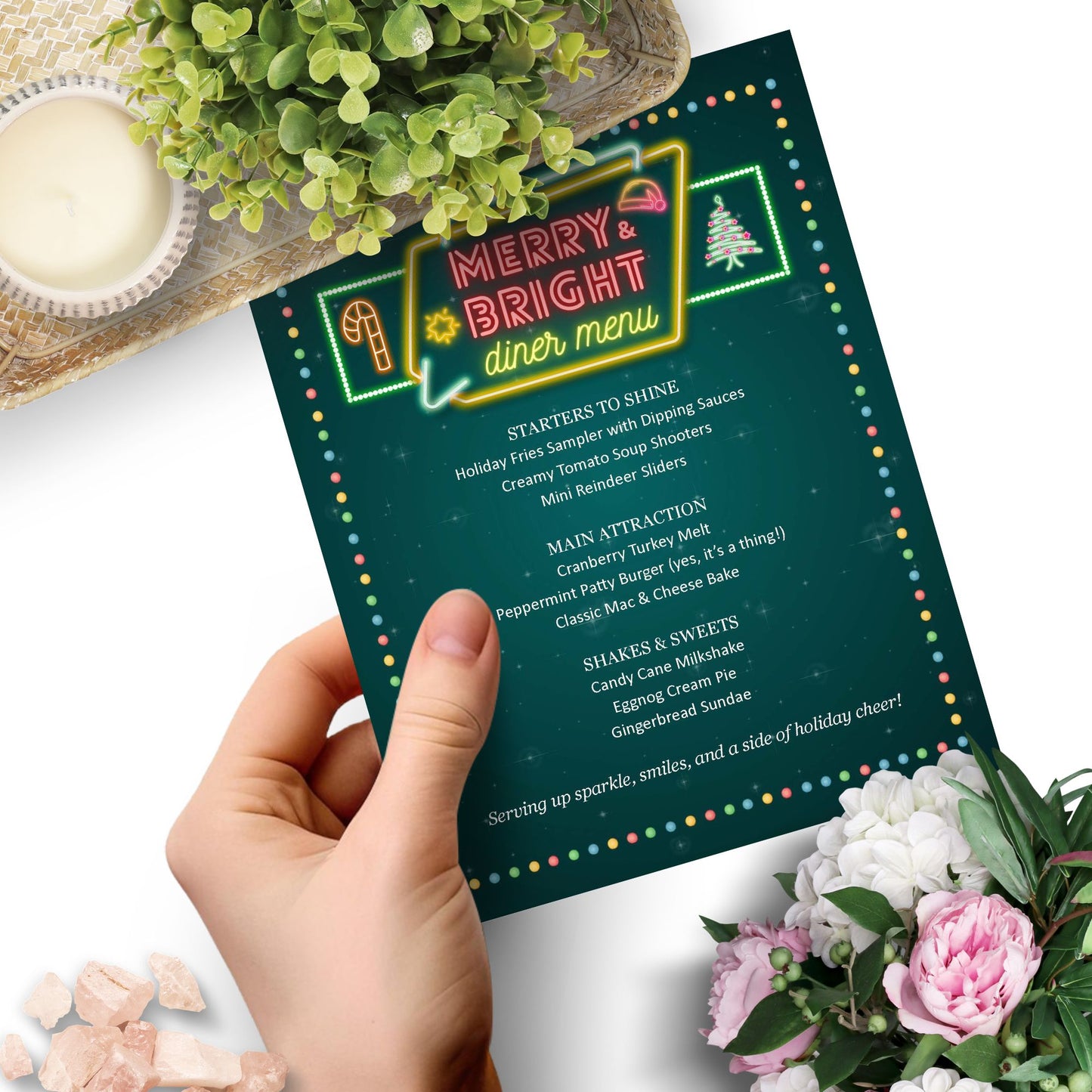 Hand holding a festive diner menu with holiday-themed food items on a decorative background.