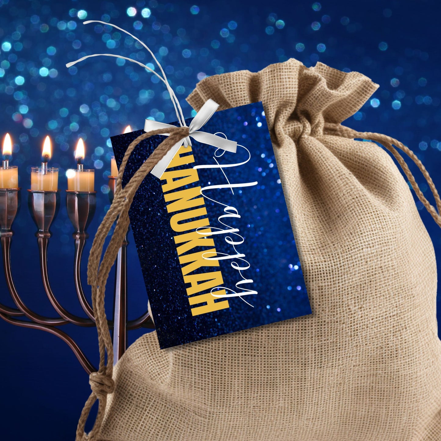 A set of Happy Hanukkah gift tags featuring "Happy Hanukkah" in white and gold text on a glittering blue background. Perfect for festive gift wrapping during the Festival of Lights.