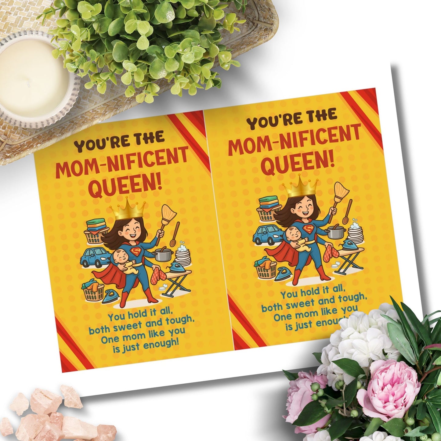 Printable 5x7 Mother’s Day card featuring a cartoon Supermom juggling a baby, cooking, ironing, and housework with a crown and cape, titled “You’re the Momnificent Queen.” Instant download PDF.