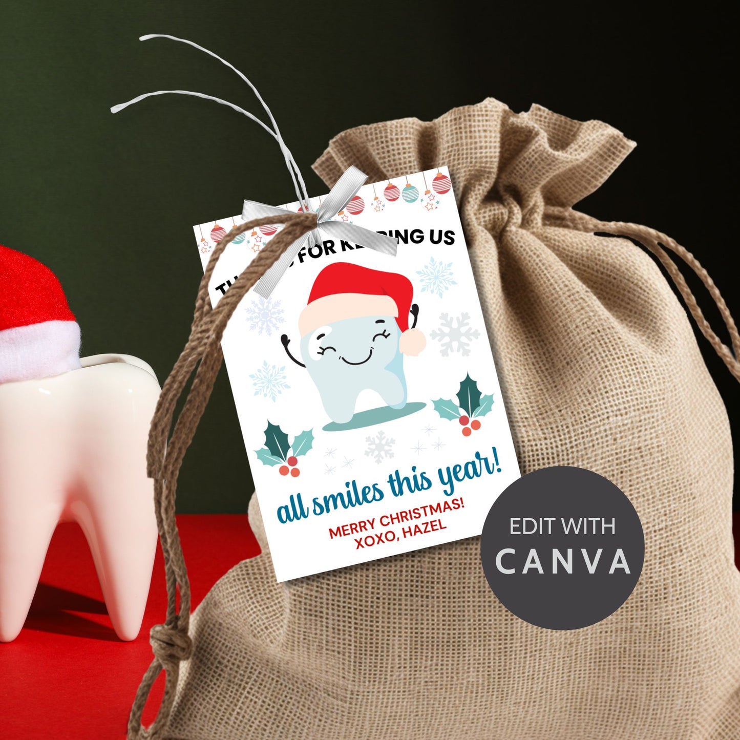A festive set of 8 editable holiday gift tags with the message 'Thanks for Keeping Us All Smiles This Year!' featuring a smiling tooth in a Santa hat, holly, snowflakes, and hanging baubles. Perfect for dentists and dental offices to use for holiday gifts or client appreciation.