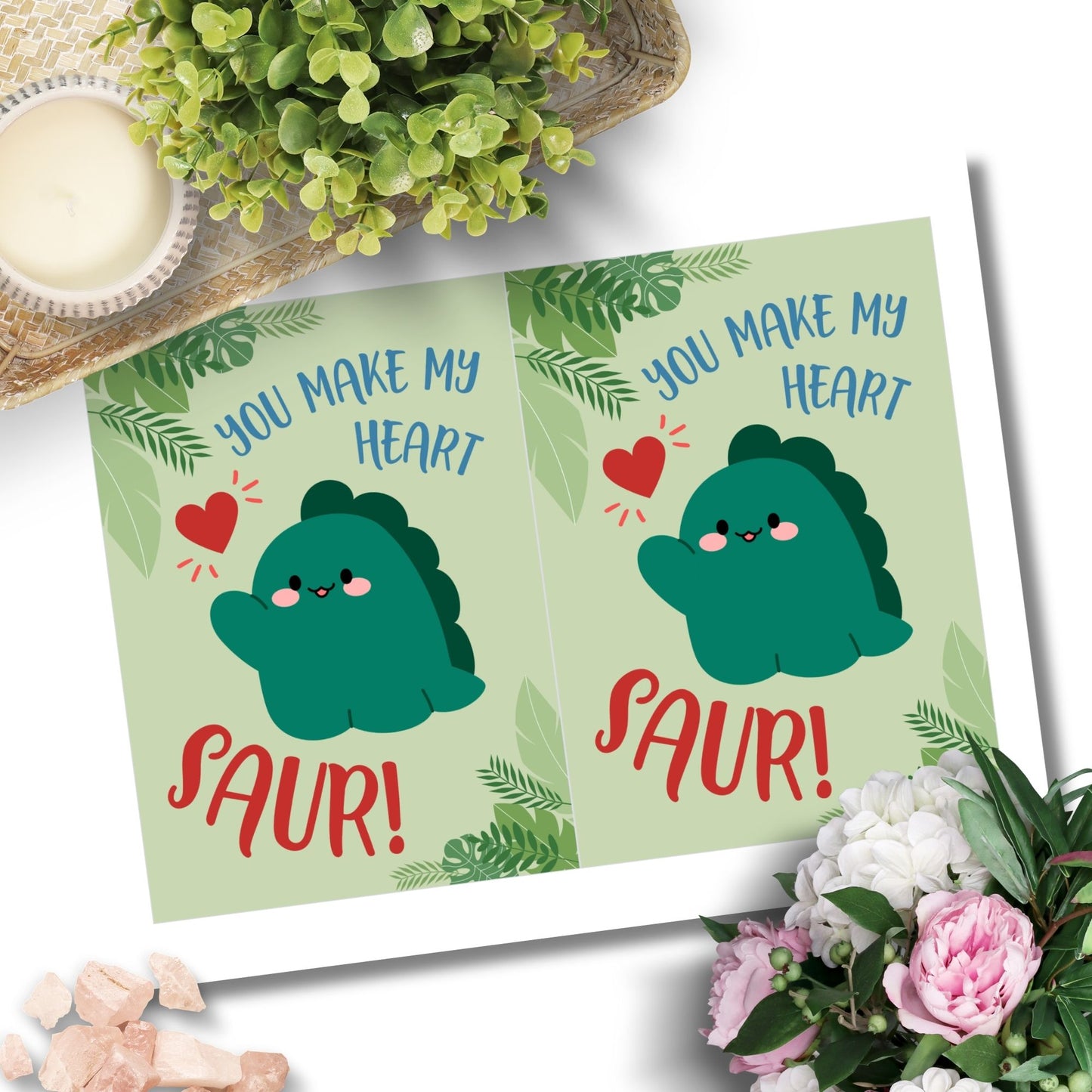 Printable Valentineās Day Greeting Card featuring the pun āYou Make My Heart Saur.ā Designed as a 5x7 PDF on an 8.5 x 11 sheet with two cards per page. A fun and adorable Valentineās card for dinosaur lovers!