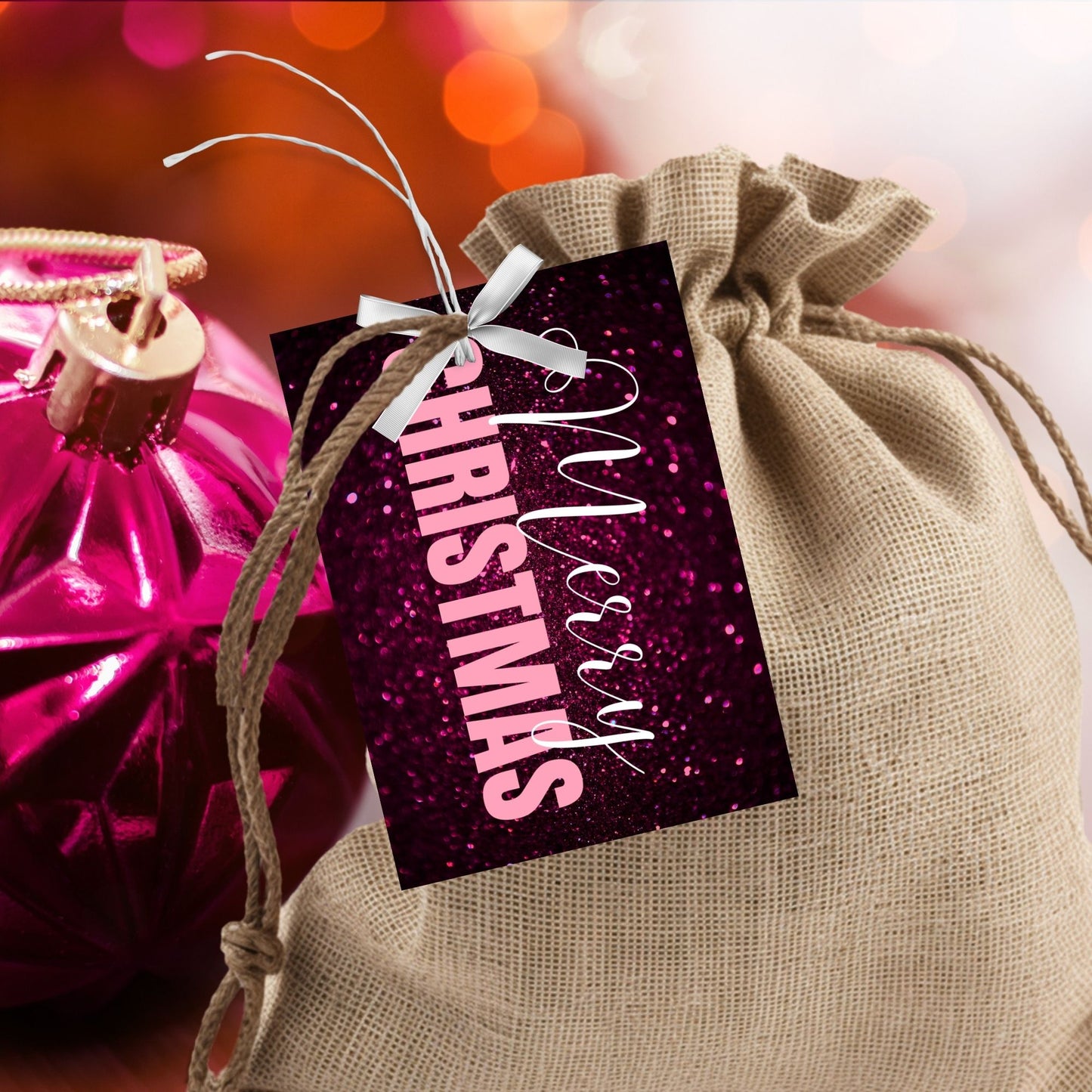Printable pink and magenta Christmas gift tags featuring a glittery magenta background with light pink "Merry Christmas" text, sized 2.5 x 3.5 inches, 8 tags per sheet.