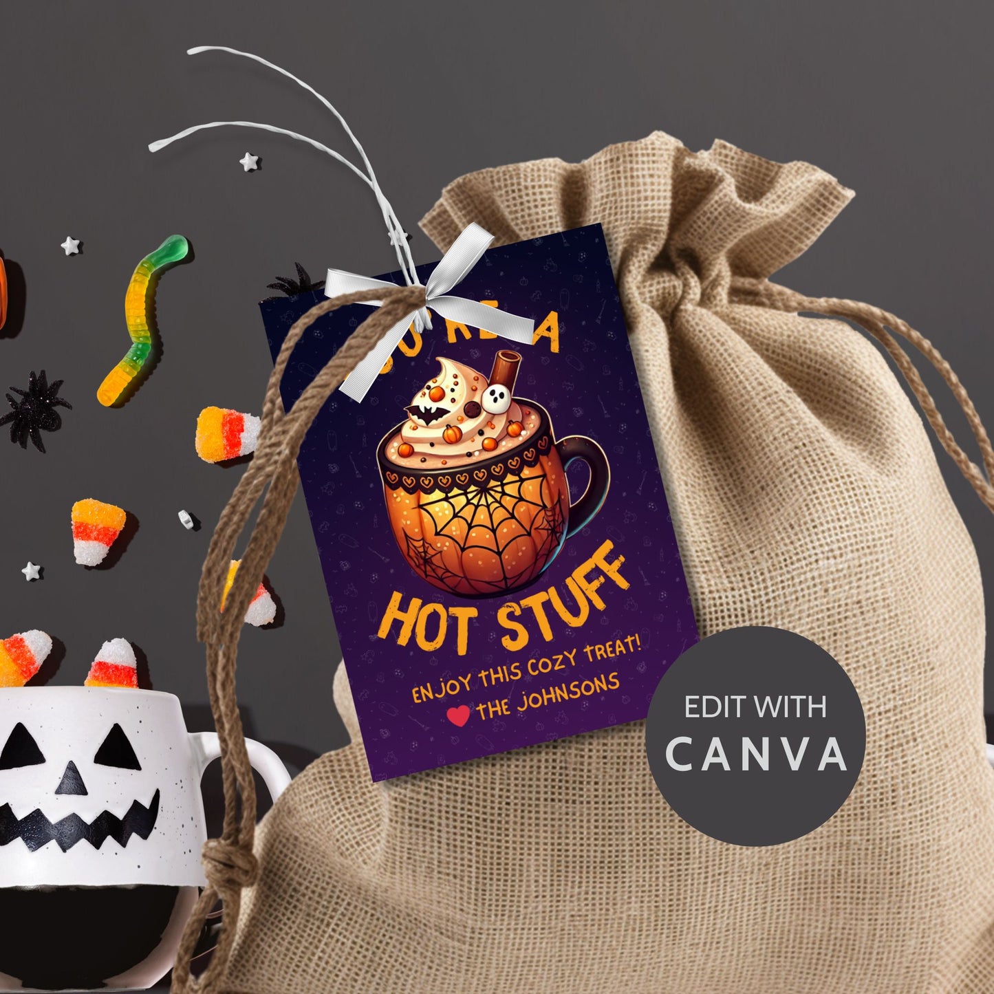 Halloween-themed printable gift tags with the message "You're a Hot Stuff" featuring a festive mug of hot cocoa on a dark purple background. Tags are 2.5 x 3.5 inches, laid out 8 per sheet on a standard 8.5 x 11-inch page. Includes a printable PDF and a PDF with a link to an editable Canva template.