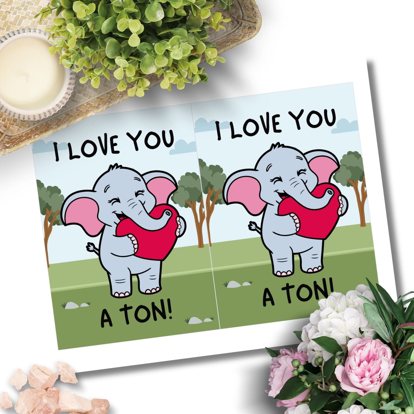 Printable Valentineās Day Greeting Card featuring the phrase āI Love You a Tonā with an elephant theme. Designed as a 5x7 PDF on an 8.5 x 11 sheet with two cards per page. A cute and heartfelt Valentineās card for loved ones.