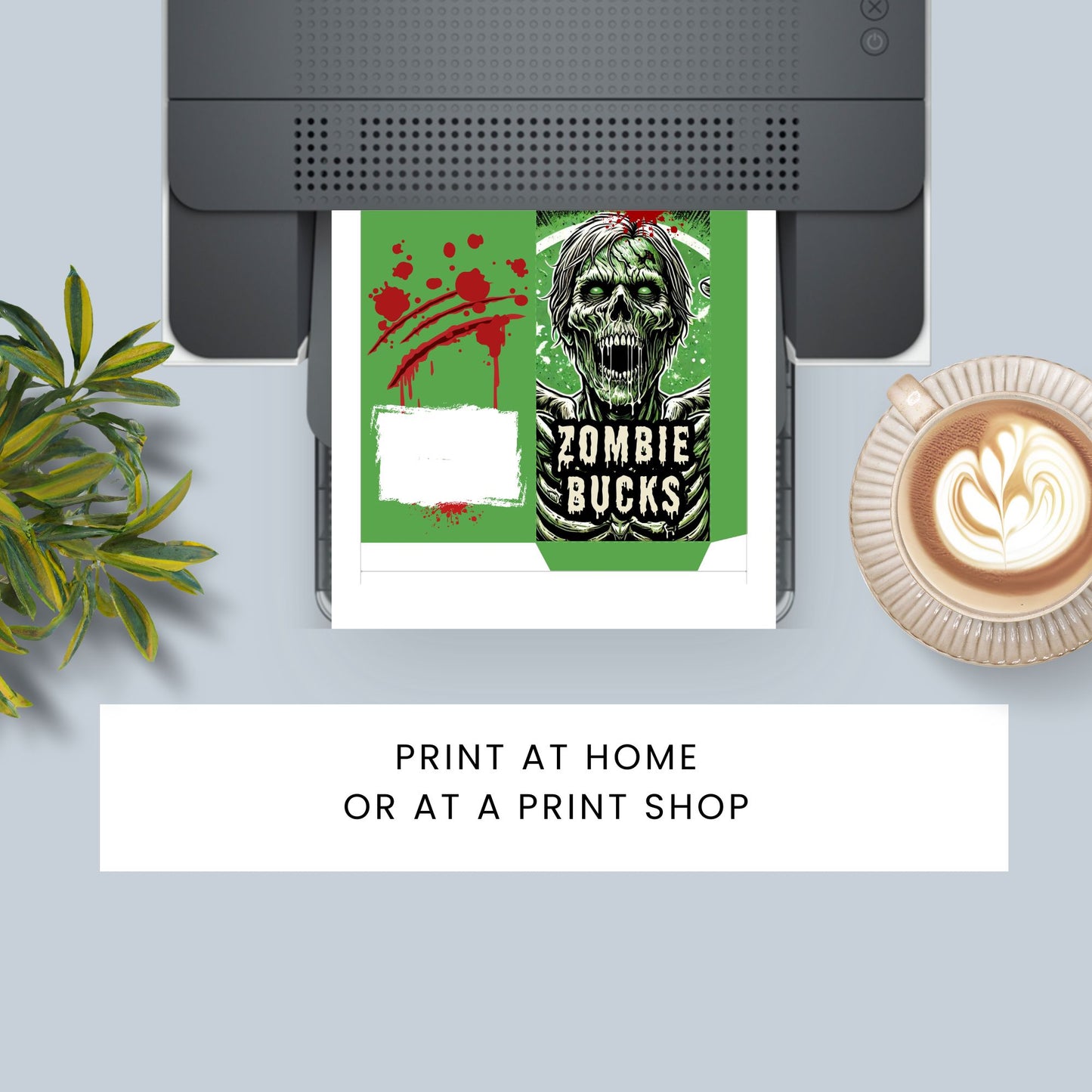 Printer with a printed design of a zombie and 'Zombie Bucks' text, next to a plant and coffee cup.