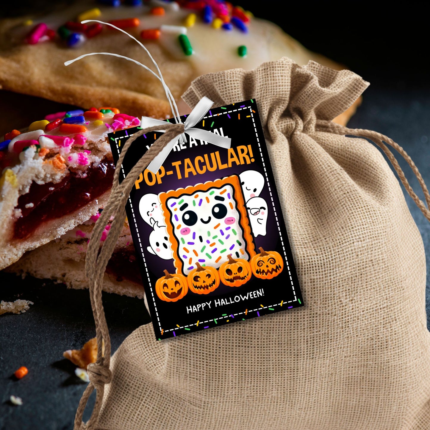 Halloween gift tag featuring a cute Pop-Tart with sprinkles, surrounded by pumpkins and ghosts, with the message 'You're a Real Pop-tacular!'