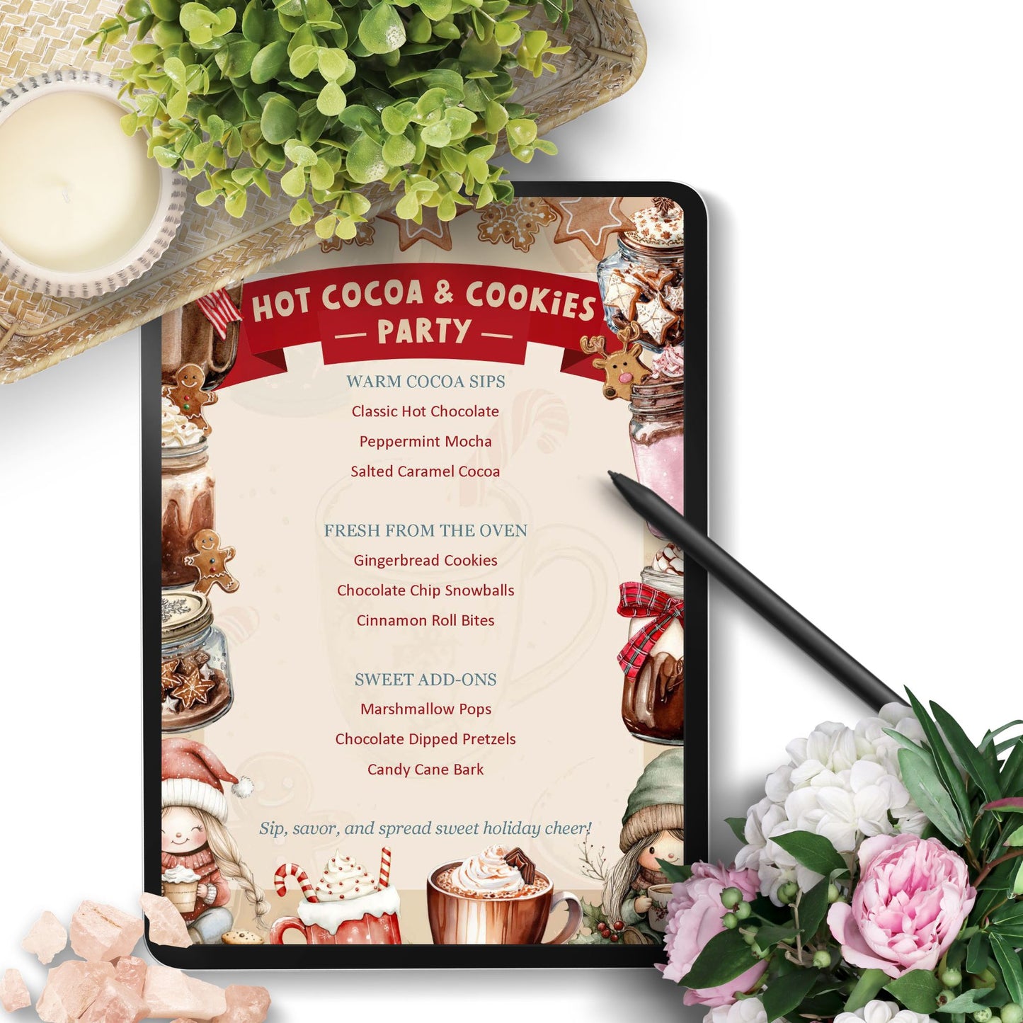 Hot cocoa and cookies party menu on a tablet with flowers and hot chocolate in the background