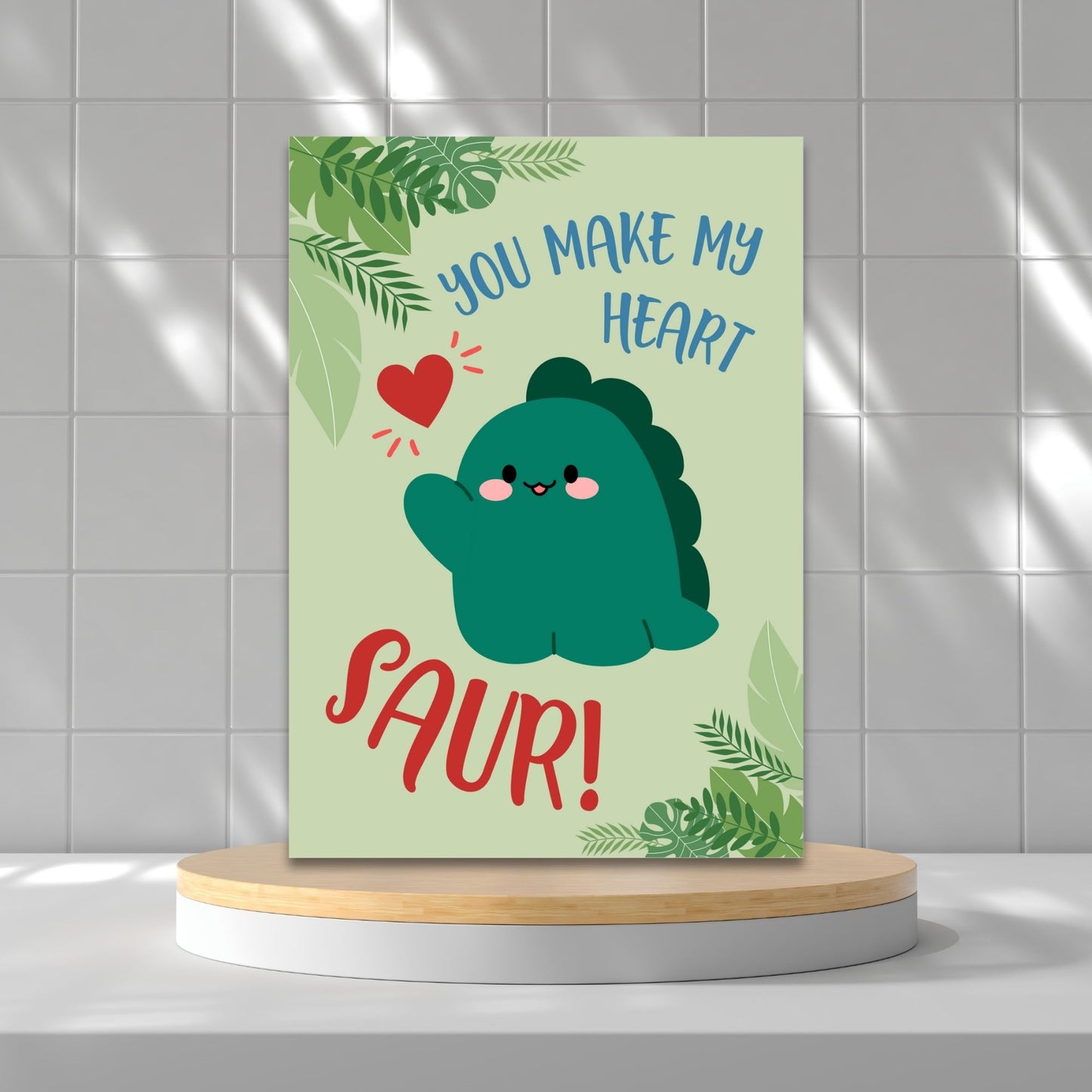 Printable Valentineās Day Greeting Card featuring the pun āYou Make My Heart Saur.ā Designed as a 5x7 PDF on an 8.5 x 11 sheet with two cards per page. A fun and adorable Valentineās card for dinosaur lovers!