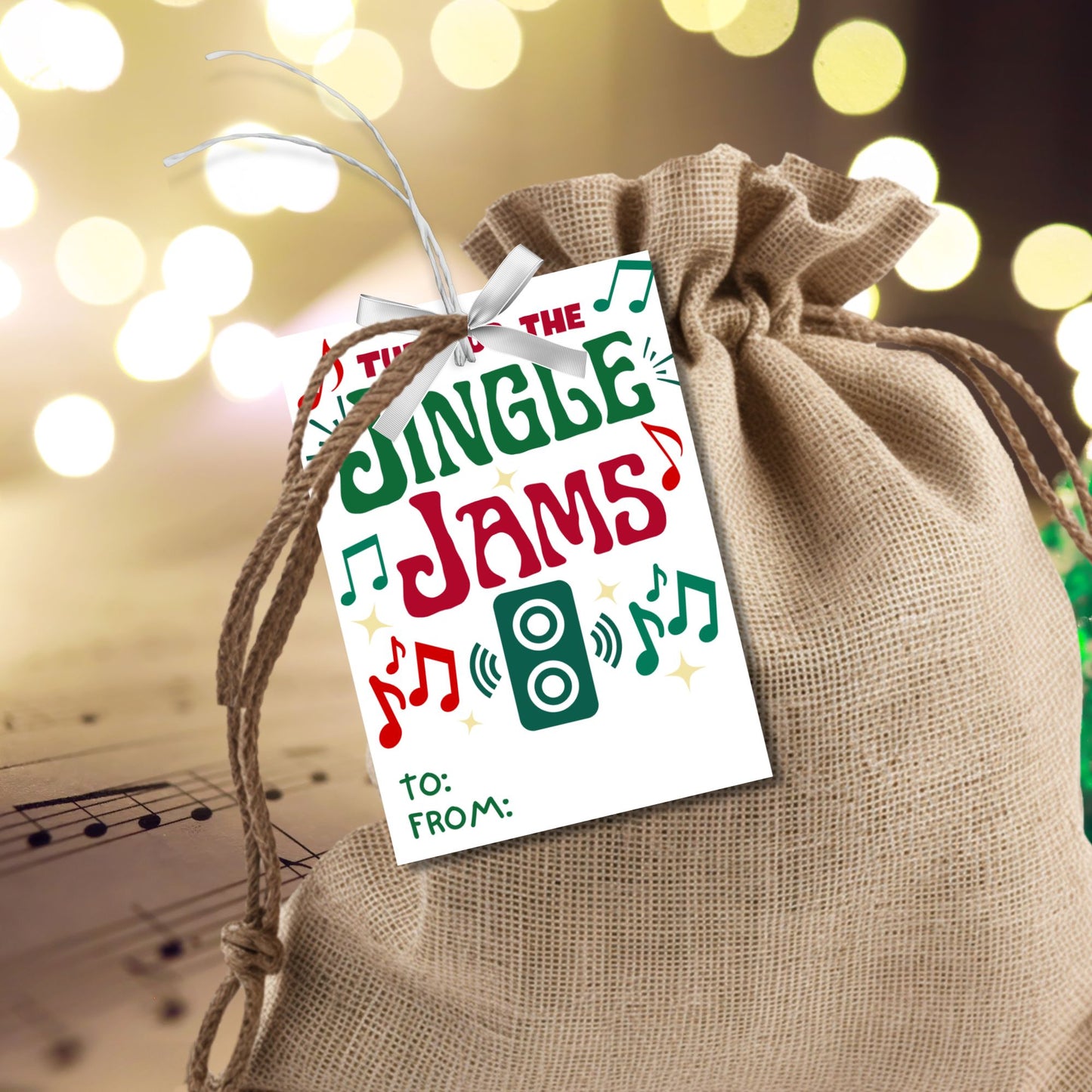Christmas gift tags with the message "Turn Up the Jingle Jams," featuring musical notes and a speaker icon, perfect for gifts like Bluetooth speakers or Christmas party favors. These printable and editable tags add a fun and festive touch.