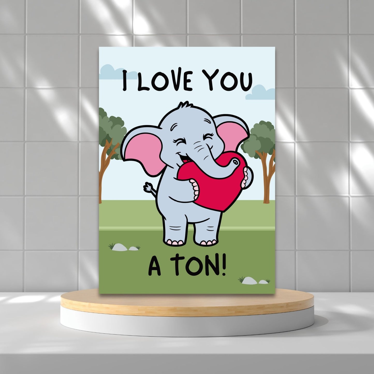Printable Valentineās Day Greeting Card featuring the phrase āI Love You a Tonā with an elephant theme. Designed as a 5x7 PDF on an 8.5 x 11 sheet with two cards per page. A cute and heartfelt Valentineās card for loved ones.