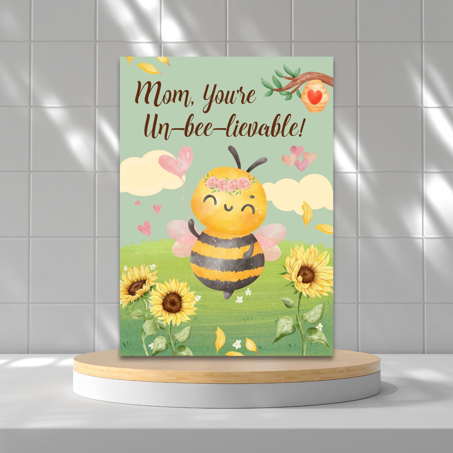 Printable 5x7 Mother’s Day card with a bee illustration and the message “Mom, You’re Unbeelievable,” featuring bright yellow and pastel colors, available as an instant download PDF.