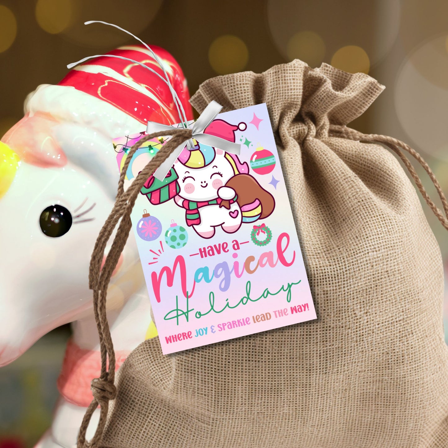 Unicorn-themed holiday gift tags with a pastel design featuring a festive unicorn carrying a gift sack, surrounded by rainbows and ornaments. Text reads 'Have a Magical Holiday.' Perfect for adding sparkle to Christmas presents.