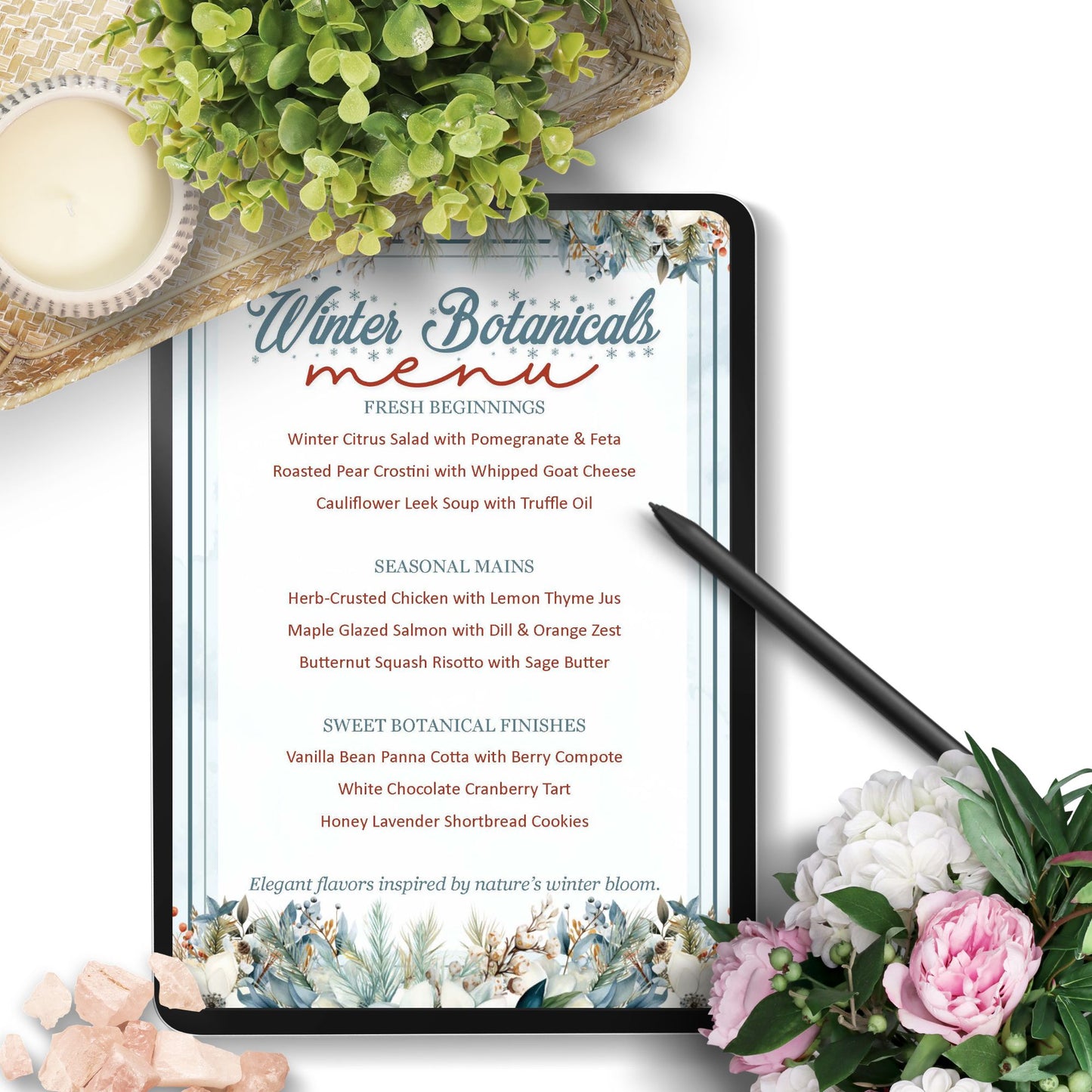 Tablet displaying a winter botanicals menu with flowers and a candle on a white surface