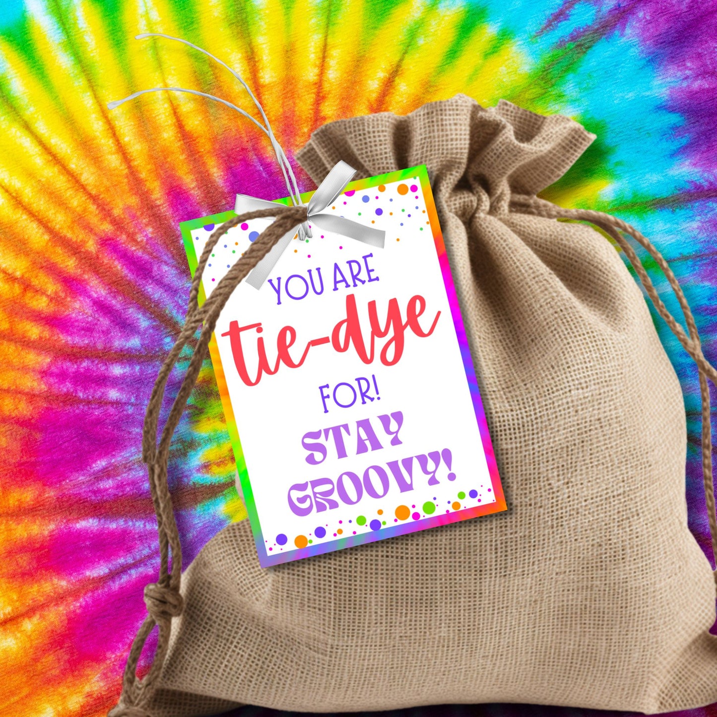 A set of eight colorful tie-dye-themed printable gift tags featuring the message 'You Are Tie-Dye For! Stay Groovy!' in vibrant fonts. The tags have a fun and bright tie-dye border with decorative dots. Perfect for teacher appreciation, employee recognition, staff thank-you gifts, and more. Available as an instant download with an editable Canva template for customization.