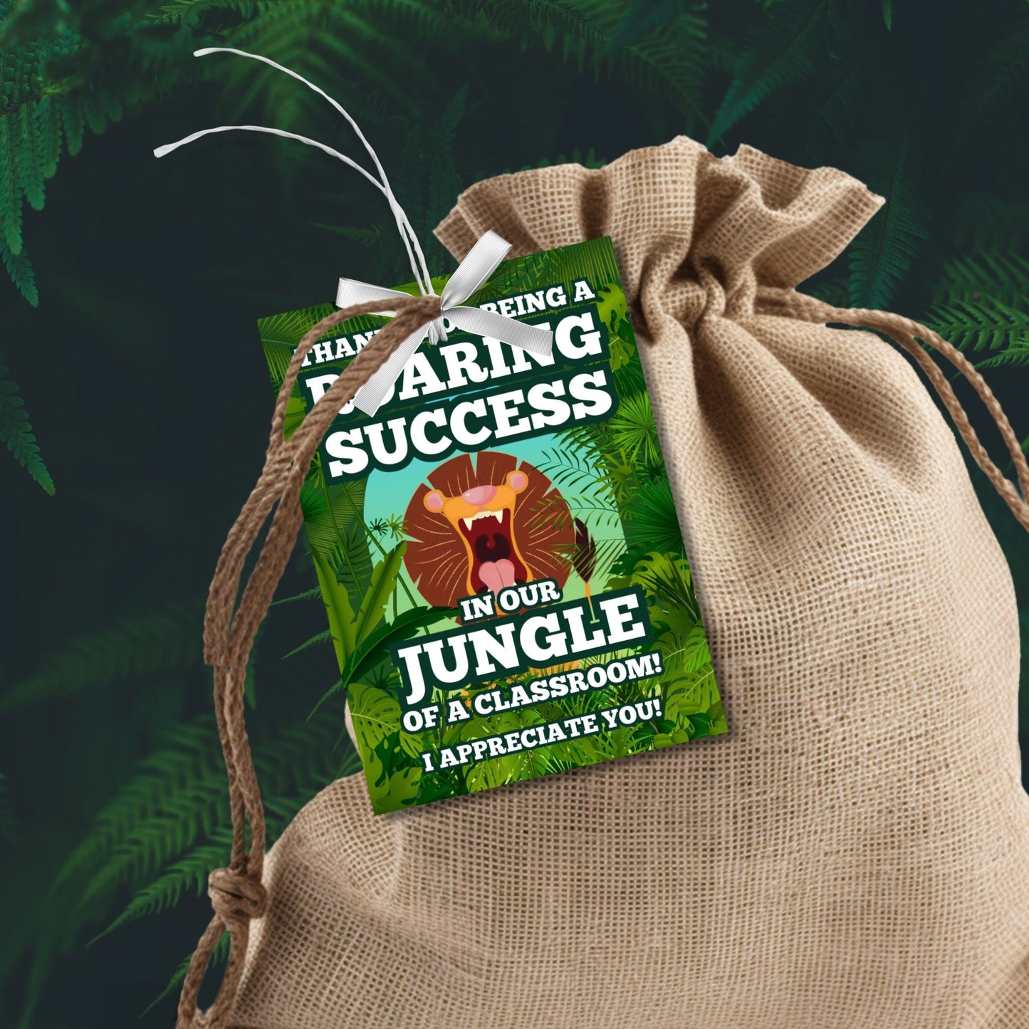 Jungle-themed teacher appreciation gift tags, featuring a roaring lion with the message "Thanks for Being a Roaring Success in Our Jungle of a Classroom!", sized 2.5 x 3.5 inches, laid out 8 per sheet on an 8.5 x 11-inch printable page. Includes editable Canva template for personalization.