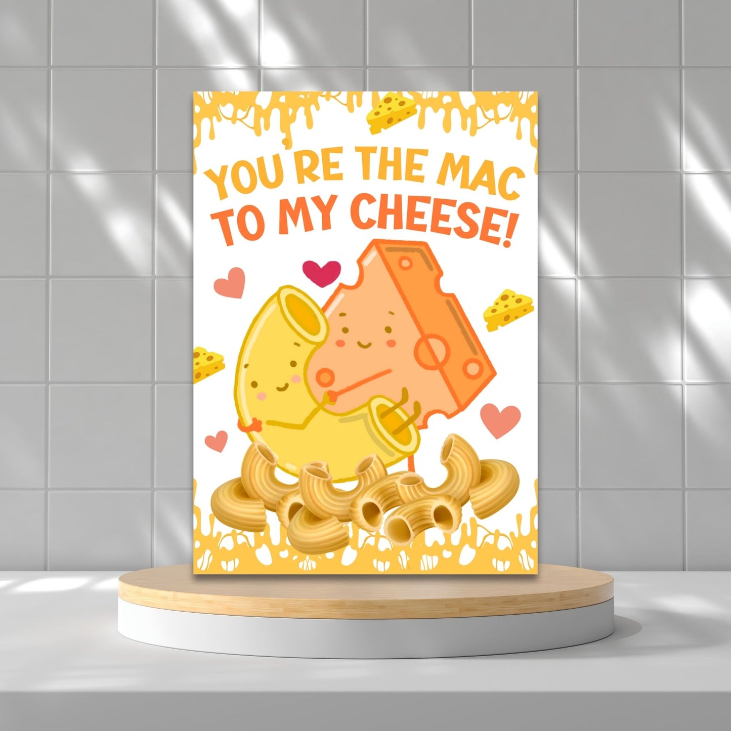 Printable Valentine’s Day Greeting Card featuring the phrase “You’re the Mac to My Cheese” with a mac and cheese theme. Designed as a 5x7 PDF on an 8.5 x 11 sheet with two cards per page. A fun and heartfelt Valentine’s card for loved ones.