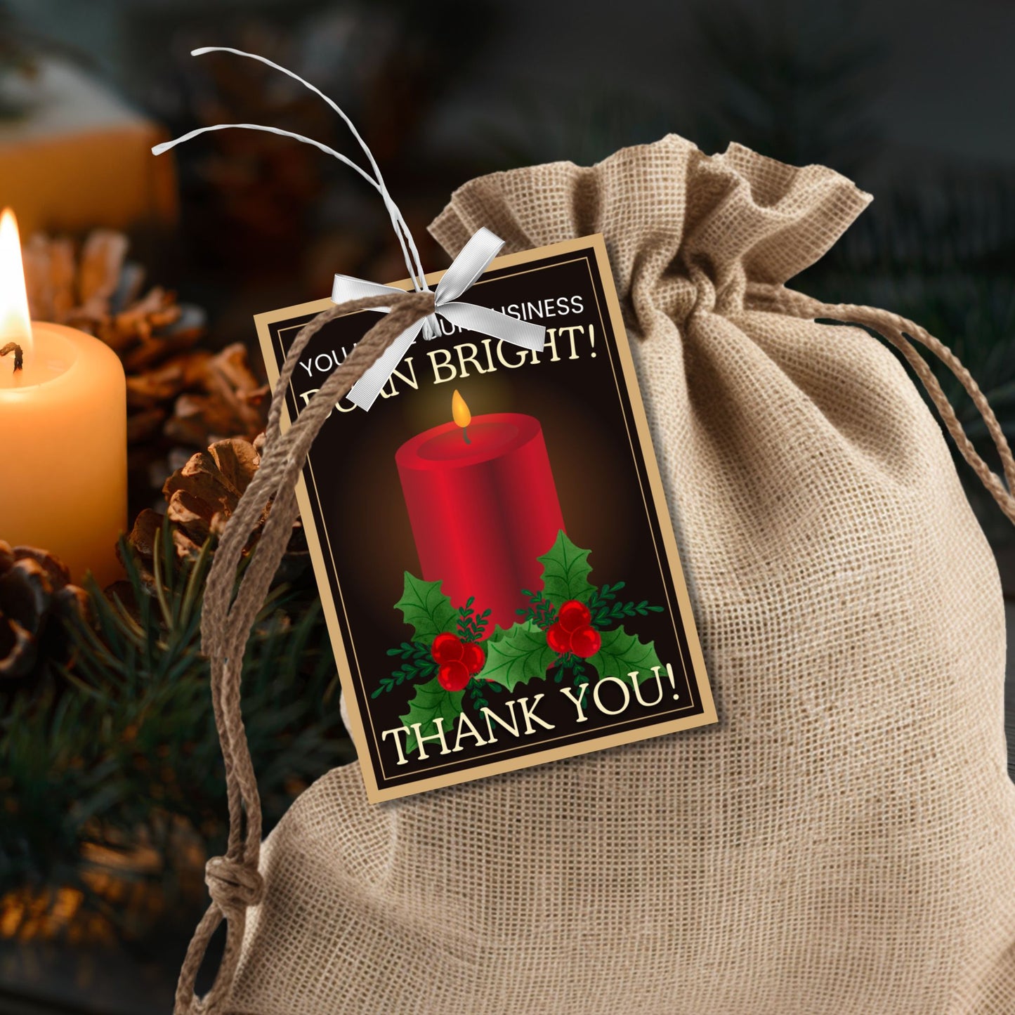Candle-themed holiday gift tags with a glowing red candle, holly decorations, and the message: "You make our business burn bright! Thank you!"