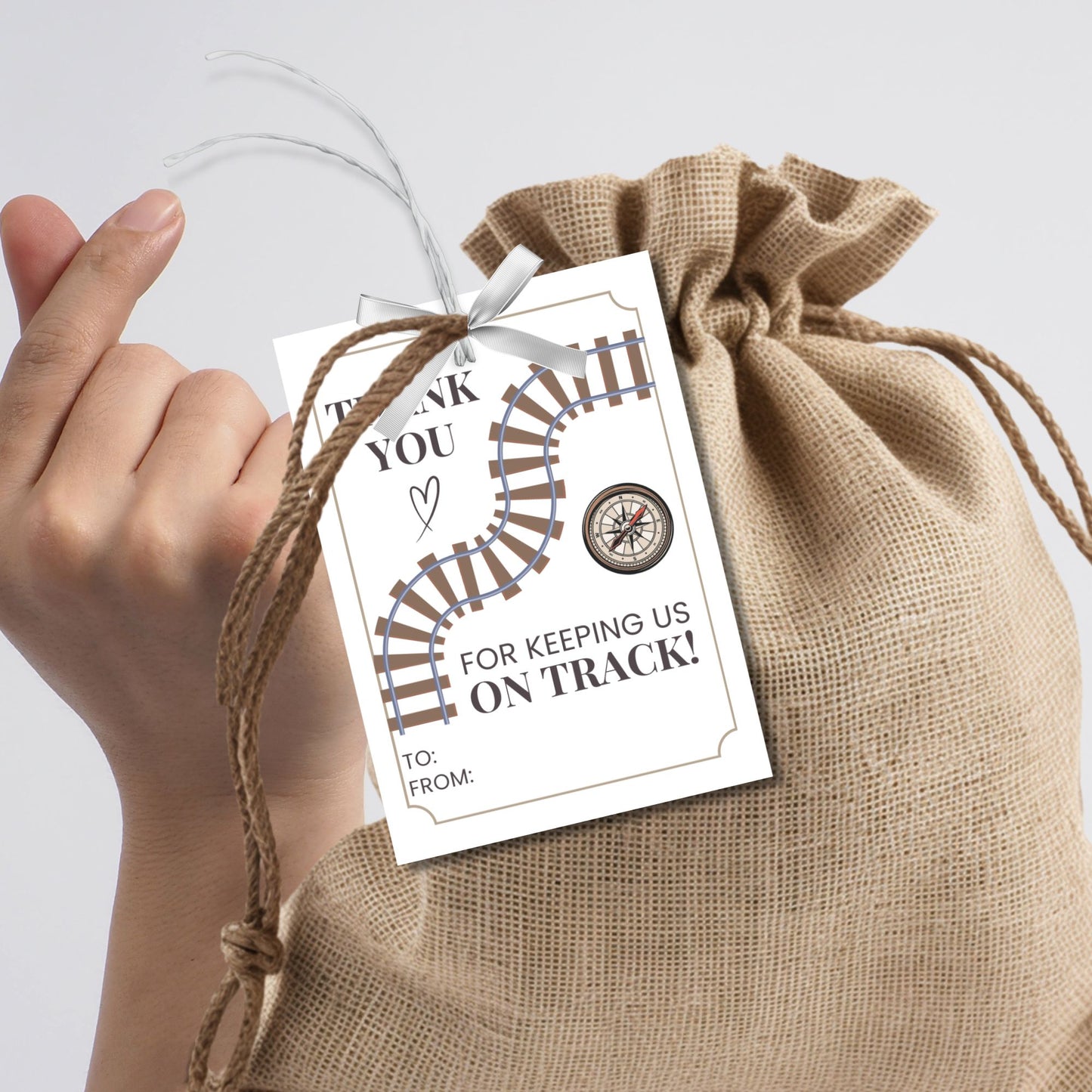 Editable National Boss's Day gift tags with a train track and compass design featuring the message "Thank You for Keeping Us on Track!" Each tag is 2.5 x 3.5 inches, 8 per sheet.