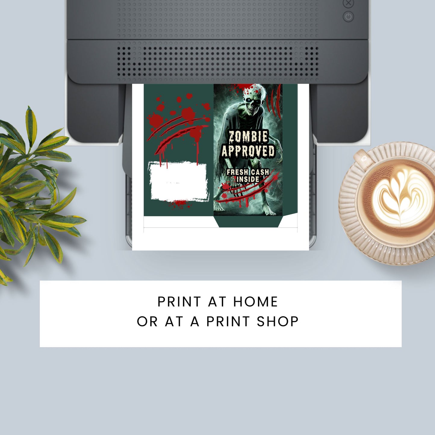 Printer with a printed book titled 'Zombie Approved' on a desk with a plant and coffee.