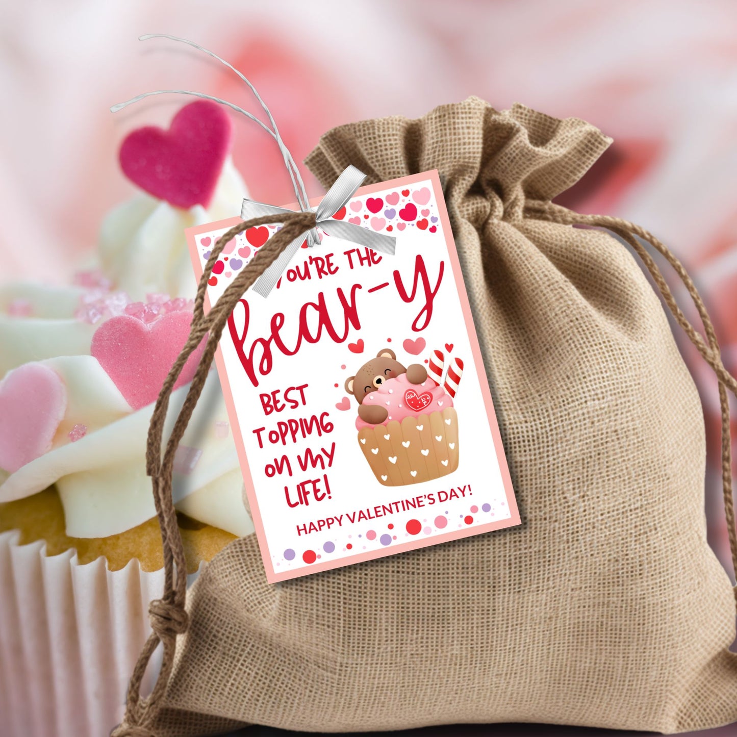 Printable and editable bear-themed Valentineās Day gift tags featuring a cute teddy bear inside a cupcake with the message "Youāre the Bear-y Best Topping on My Life!" Perfect for pairing with cupcakes, plush bears, and sweet treats.