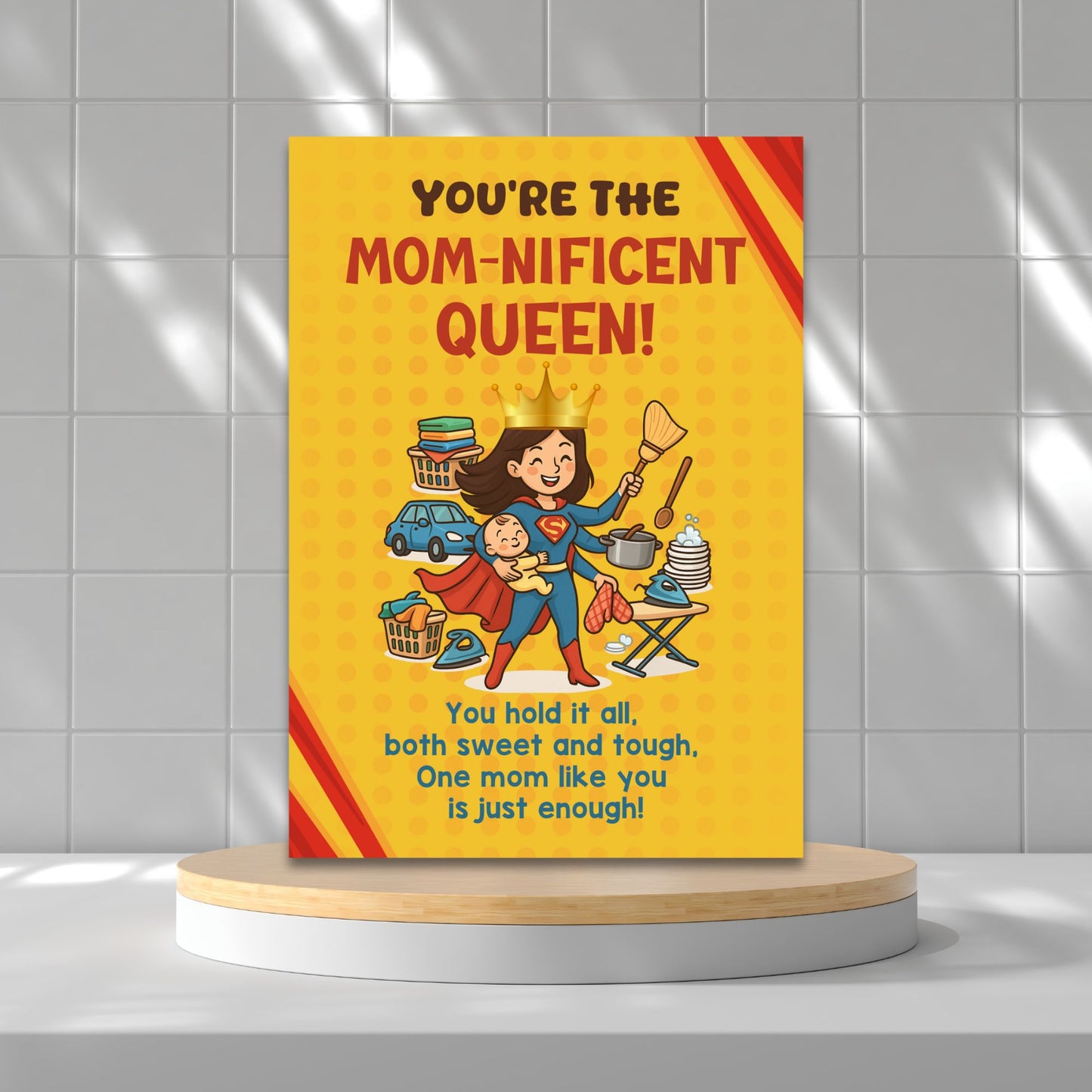 Printable 5x7 Mother’s Day card featuring a cartoon Supermom juggling a baby, cooking, ironing, and housework with a crown and cape, titled “You’re the Momnificent Queen.” Instant download PDF.
