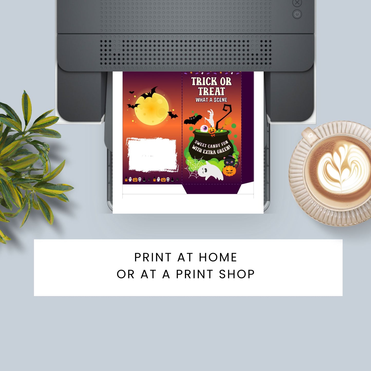 Halloween-themed print design on a printer with a cup of coffee and plant in the background.