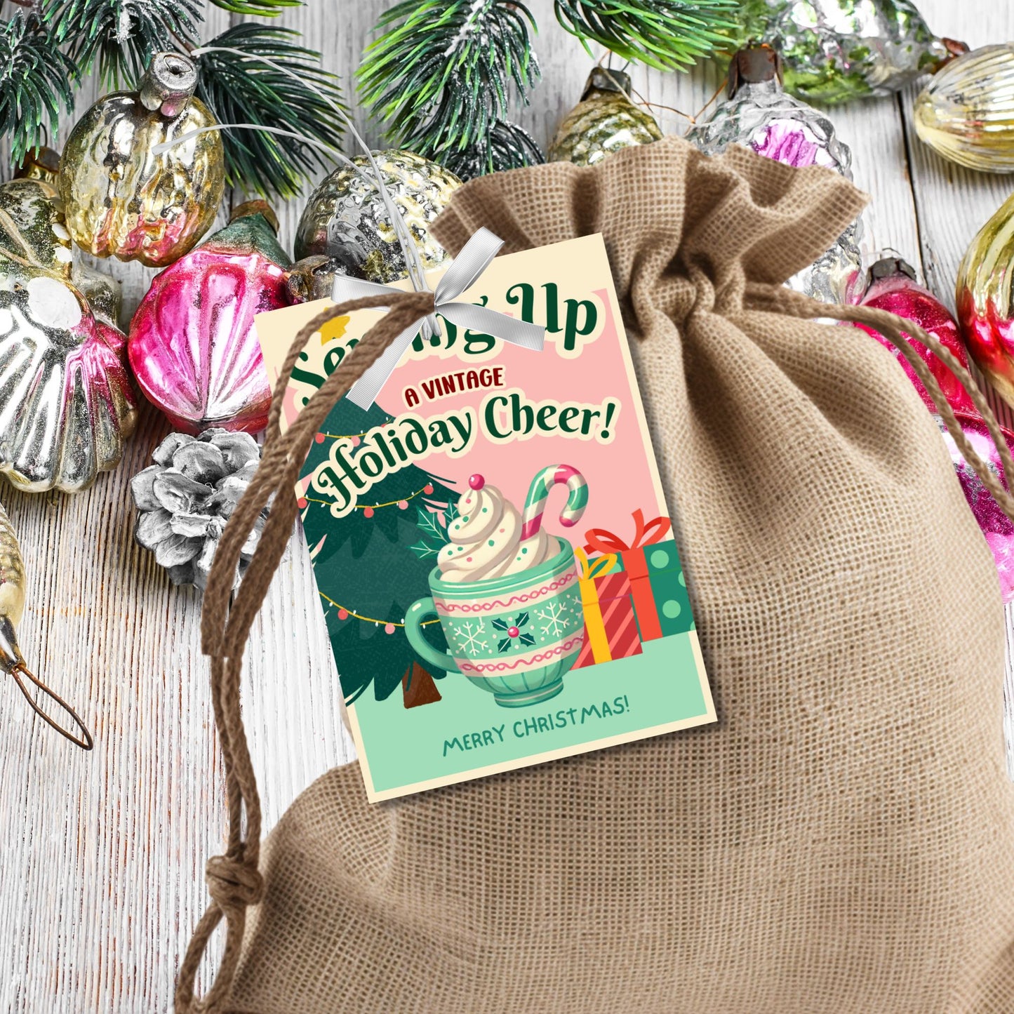 Retro-inspired Christmas gift tags featuring a cozy mug of whipped cream with a candy cane, a Christmas tree, and presents, paired with the message "Serving Up a Vintage Holiday Cheer!" These printable and editable tags add a charming, nostalgic touch to holiday gifts.