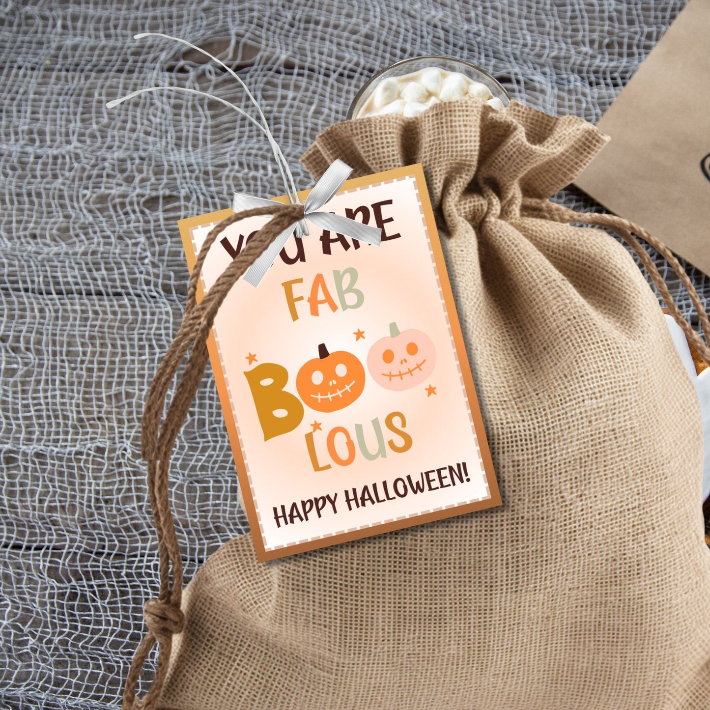 Printable Halloween gift tags with a warm color scheme, featuring the message "You Are FAB-BOO-LOUS" with cute smiling pumpkins, perfect for gifts and party favors.
