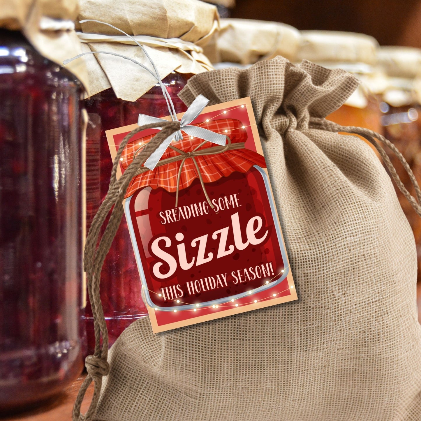 Printable "Spreading Some Sizzle This Holiday Season!" gift tags with a festive jar design, perfect for bourbon bacon jam or any spreadable treat. Includes printable PDF and editable Canva template.