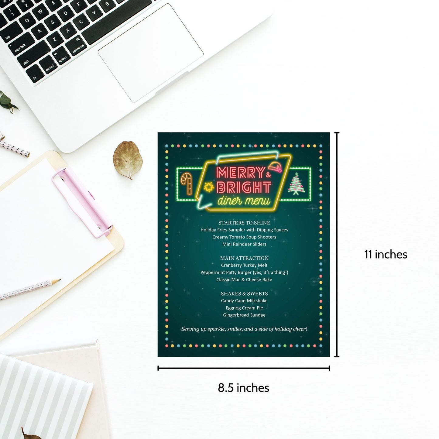 Menu card with 'Merry & Bright Diner Menu' design on a desk with laptop and stationery items.