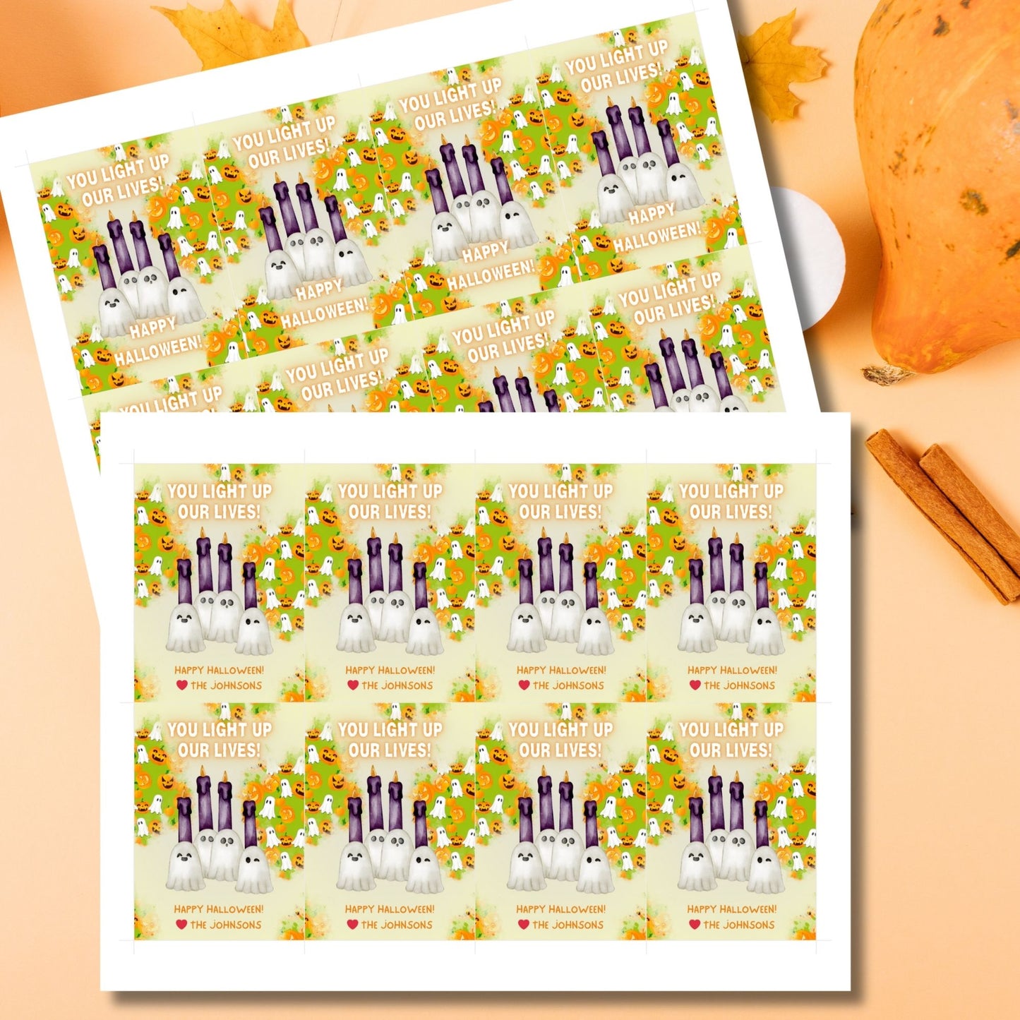 Halloween-themed printable gift tags with the message "You Light Up Our Lives!" designed for candle gifts, featuring cute ghost characters and glowing candles on a festive background. Tags are 2.5 x 3.5 inches, laid out 8 per sheet on a standard 8.5 x 11-inch page. Includes a printable PDF and a PDF with a link to an editable Canva template.