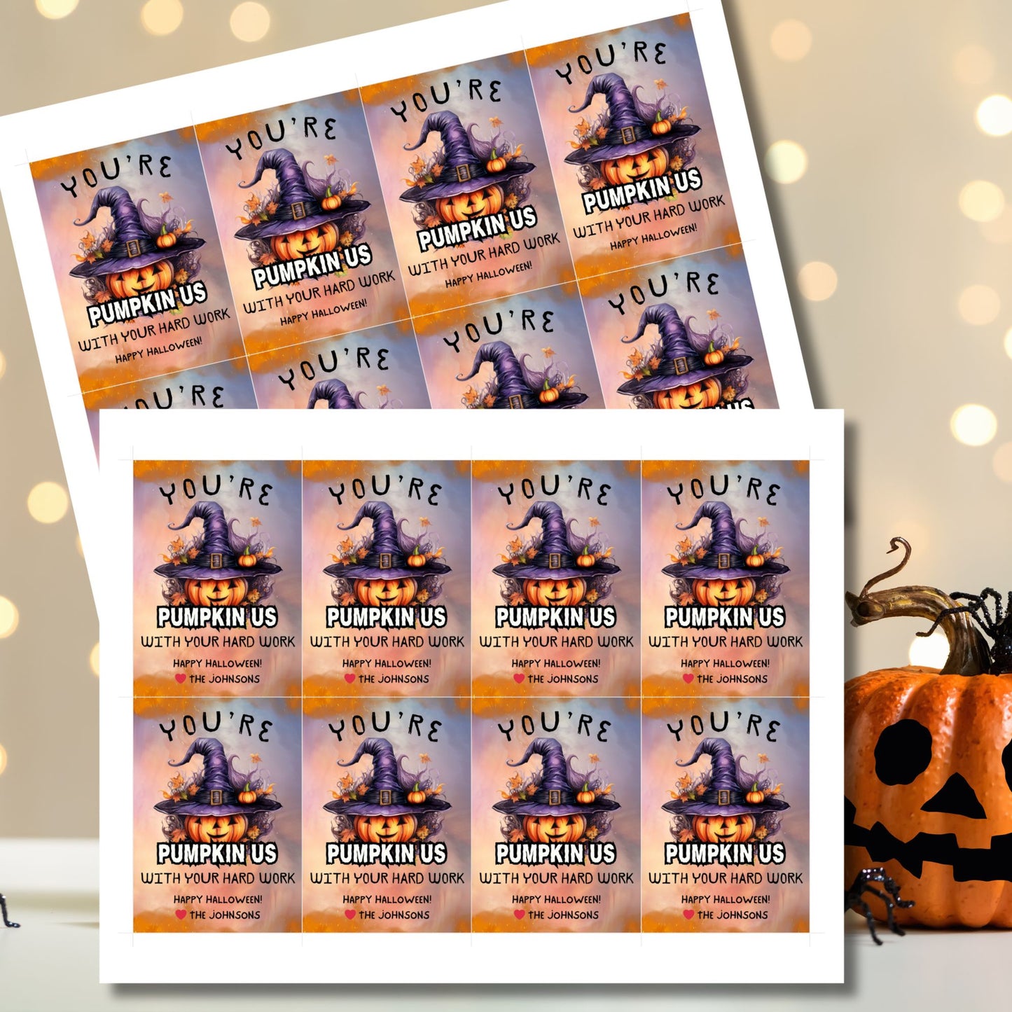 Halloween-themed printable gift tags with the message "You're Pumpkin Us With Your Hard Work" featuring a festive pumpkin in a witch's hat on a Halloween background. Tags are 2.5 x 3.5 inches, laid out 8 per sheet on a standard 8.5 x 11-inch page. Includes a printable PDF and a PDF with a link to an editable Canva template.