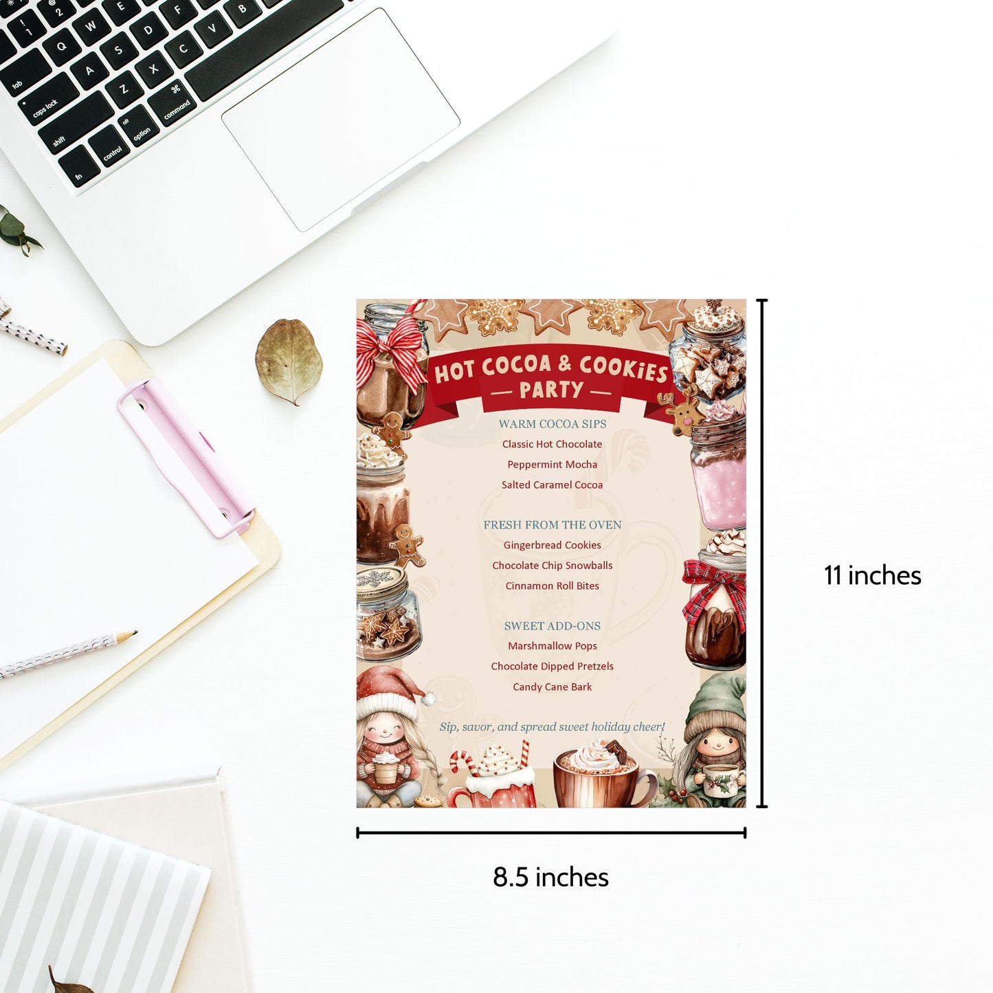 Invitation card for a 'Hot Cocoa & Cookies Party' on a desk with laptop and stationery items.