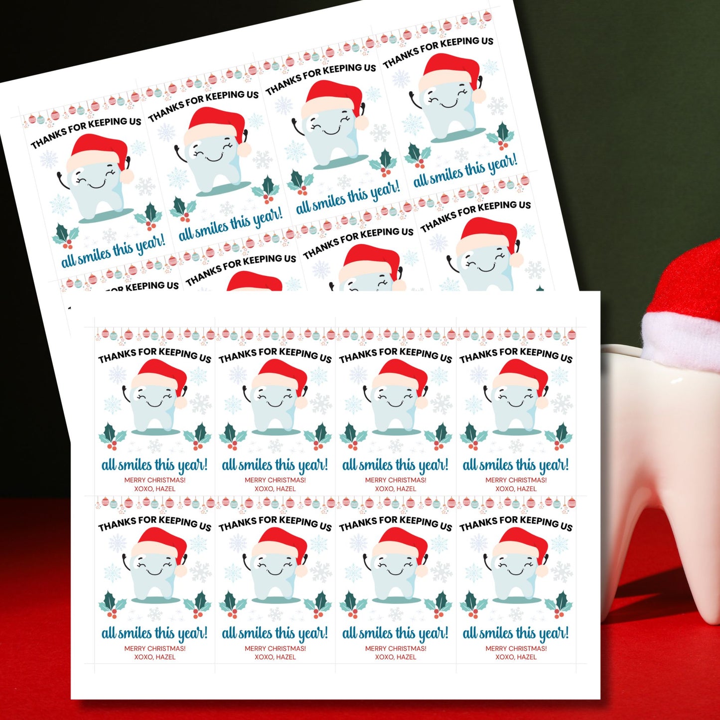 A festive set of 8 editable holiday gift tags with the message 'Thanks for Keeping Us All Smiles This Year!' featuring a smiling tooth in a Santa hat, holly, snowflakes, and hanging baubles. Perfect for dentists and dental offices to use for holiday gifts or client appreciation.