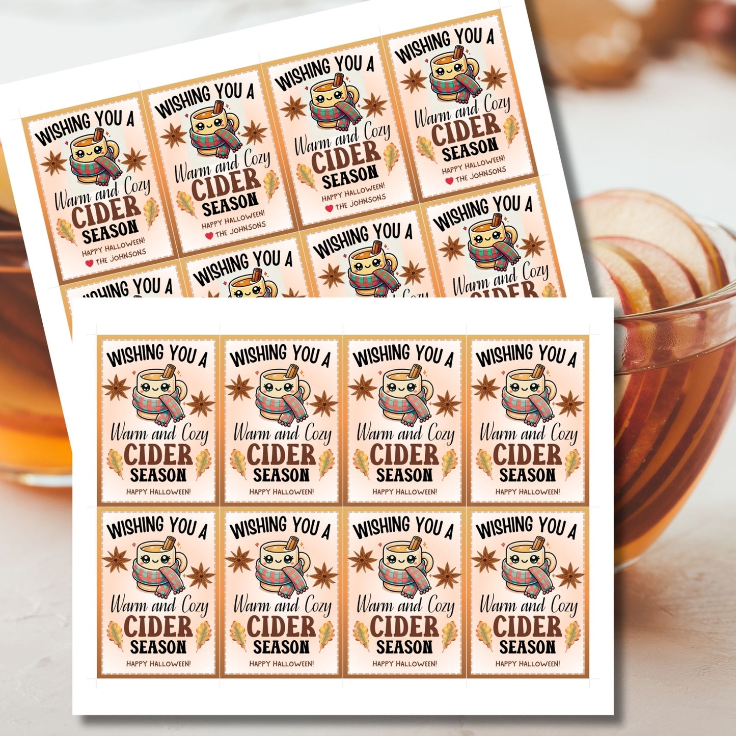 A printable Halloween gift tag featuring a warm and cozy cider theme. The tag displays a cute mug wrapped in a scarf, surrounded by autumn leaves and star anise, with the message "Wishing You a Warm and Cozy Cider Season."