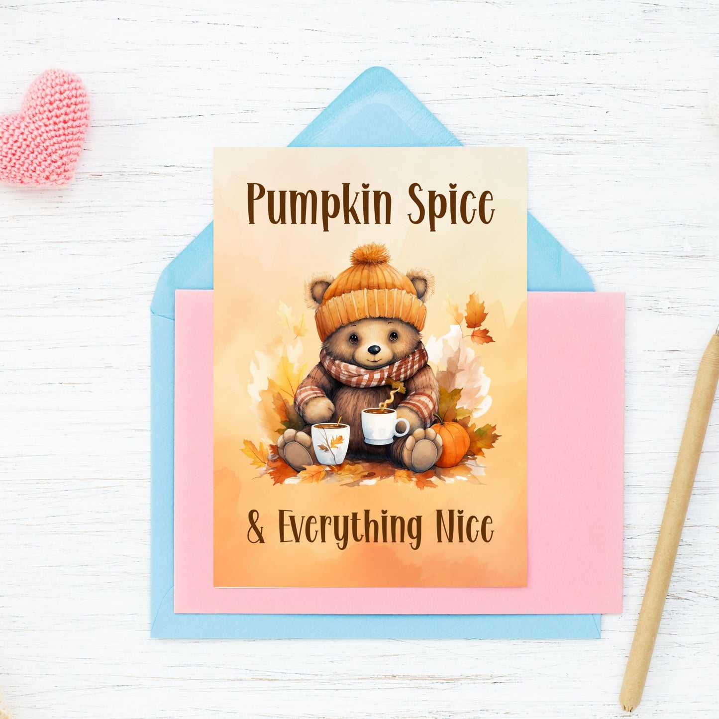 Card with a bear holding coffee cups and pumpkins, text 'Pumpkin Spice & Everything Nice', on a colorful envelope.
